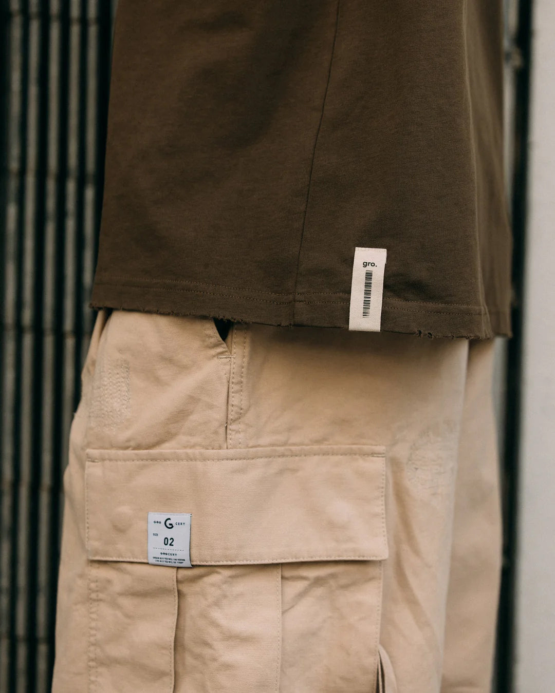 A Eckhaus Latta Shirt pictured on a model in front of a white background. The title of the product is Eckhaus Latta Eclipse Turtleneck - Stone and the image was taken by 199A®.