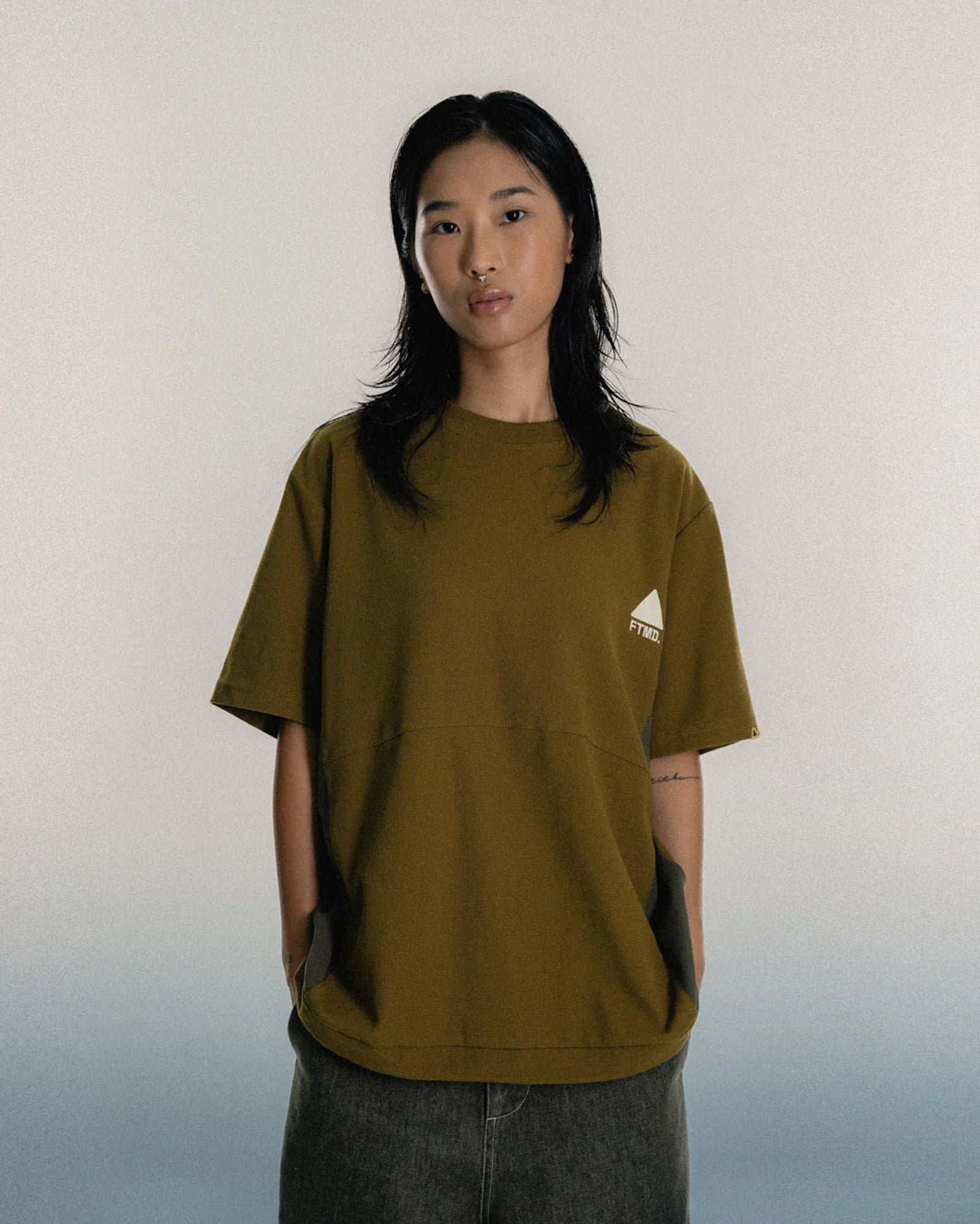 A Eckhaus Latta Shirt pictured on a model in front of a white background. The title of the product is Eckhaus Latta Eclipse Turtleneck - Stone and the image was taken by 199A®.