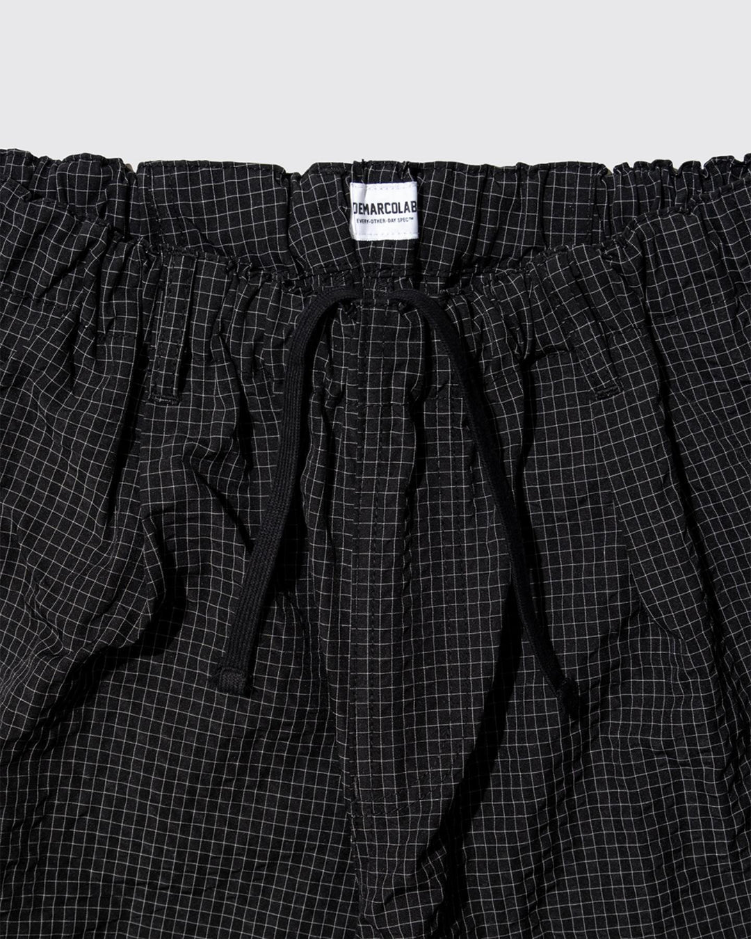 A Eckhaus Latta Shirt pictured on a model in front of a white background. The title of the product is Eckhaus Latta Eclipse Turtleneck - Stone and the image was taken by 199A®.
