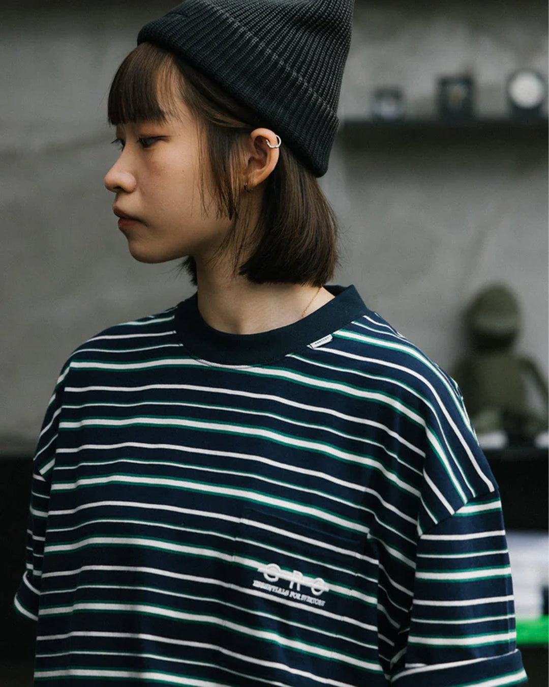 A Eckhaus Latta Shirt pictured on a model in front of a white background. The title of the product is Eckhaus Latta Eclipse Turtleneck - Stone and the image was taken by 199A®.