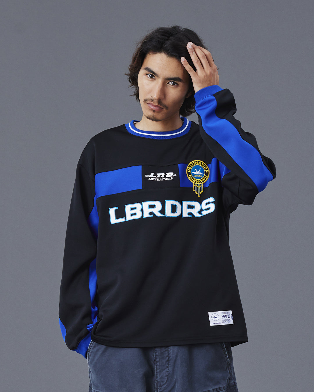 A Eckhaus Latta Shirt pictured on a model in front of a white background. The title of the product is Eckhaus Latta Eclipse Turtleneck - Stone and the image was taken by 199A®.