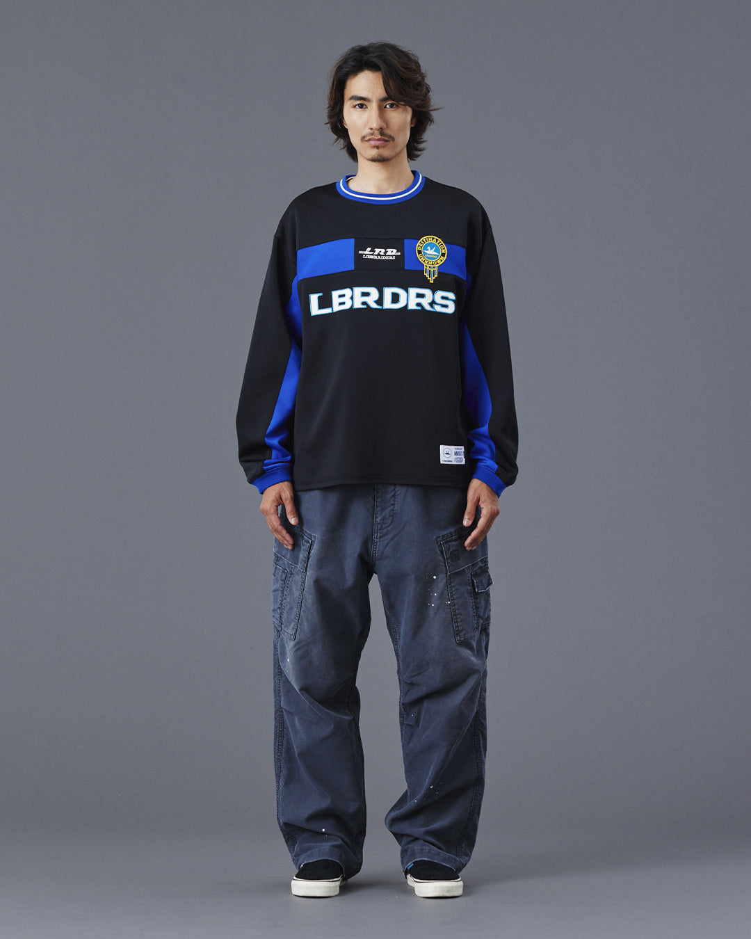 A Eckhaus Latta Shirt pictured on a model in front of a white background. The title of the product is Eckhaus Latta Eclipse Turtleneck - Stone and the image was taken by 199A®.