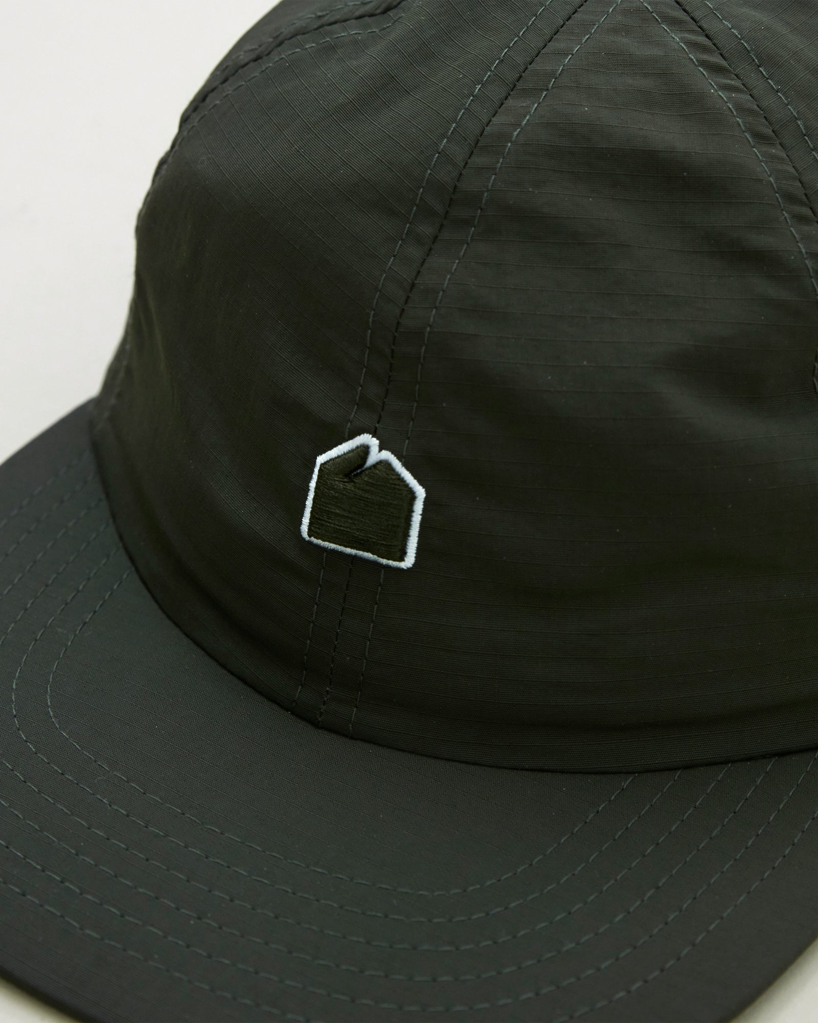 A Eckhaus Latta Shirt pictured on a model in front of a white background. The title of the product is Eckhaus Latta Eclipse Turtleneck - Stone and the image was taken by 199A®.