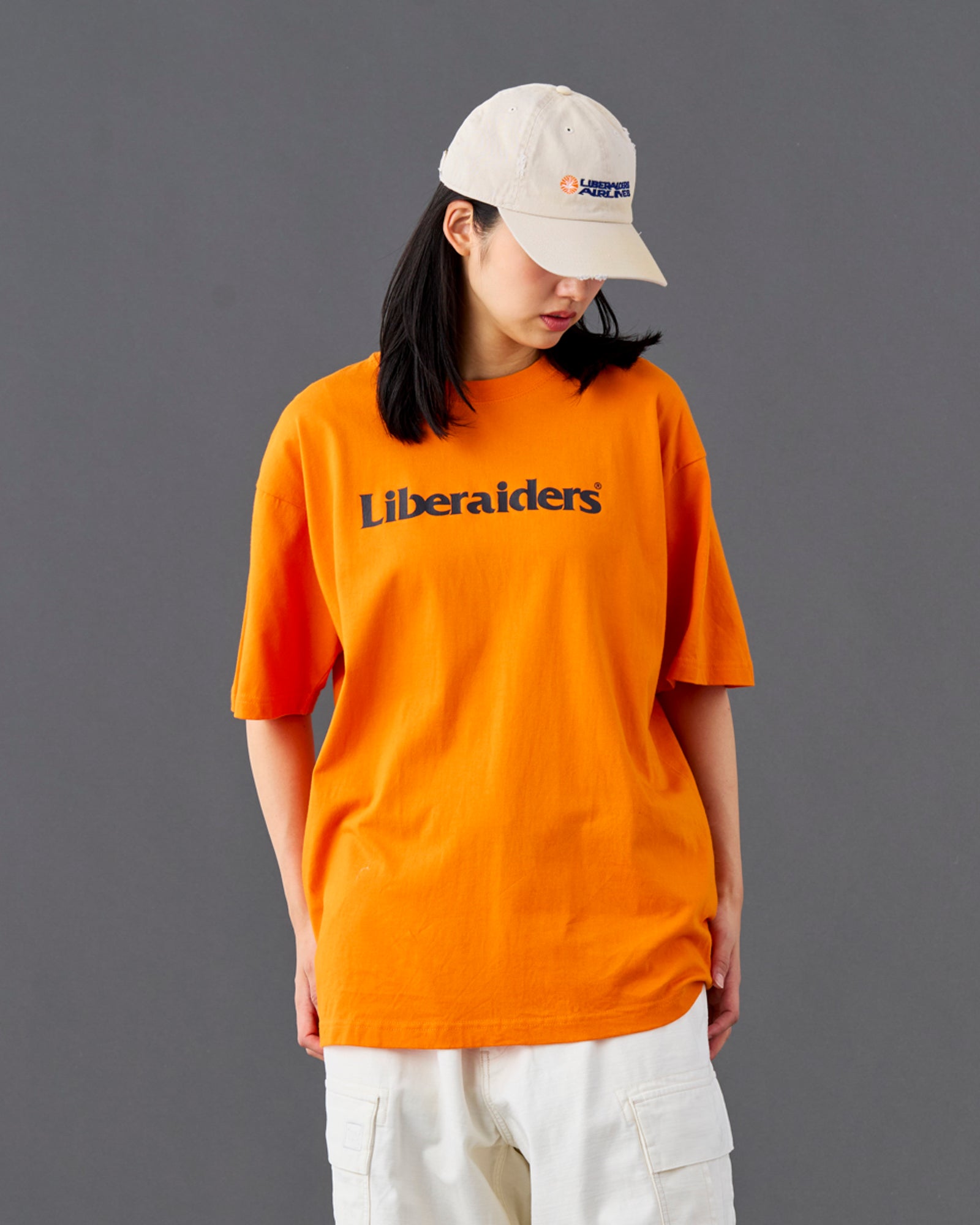 A Eckhaus Latta Shirt pictured on a model in front of a white background. The title of the product is Eckhaus Latta Eclipse Turtleneck - Stone and the image was taken by 199A®.