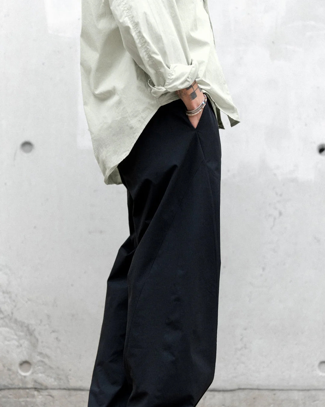 A Eckhaus Latta Shirt pictured on a model in front of a white background. The title of the product is Eckhaus Latta Eclipse Turtleneck - Stone and the image was taken by 199A®.
