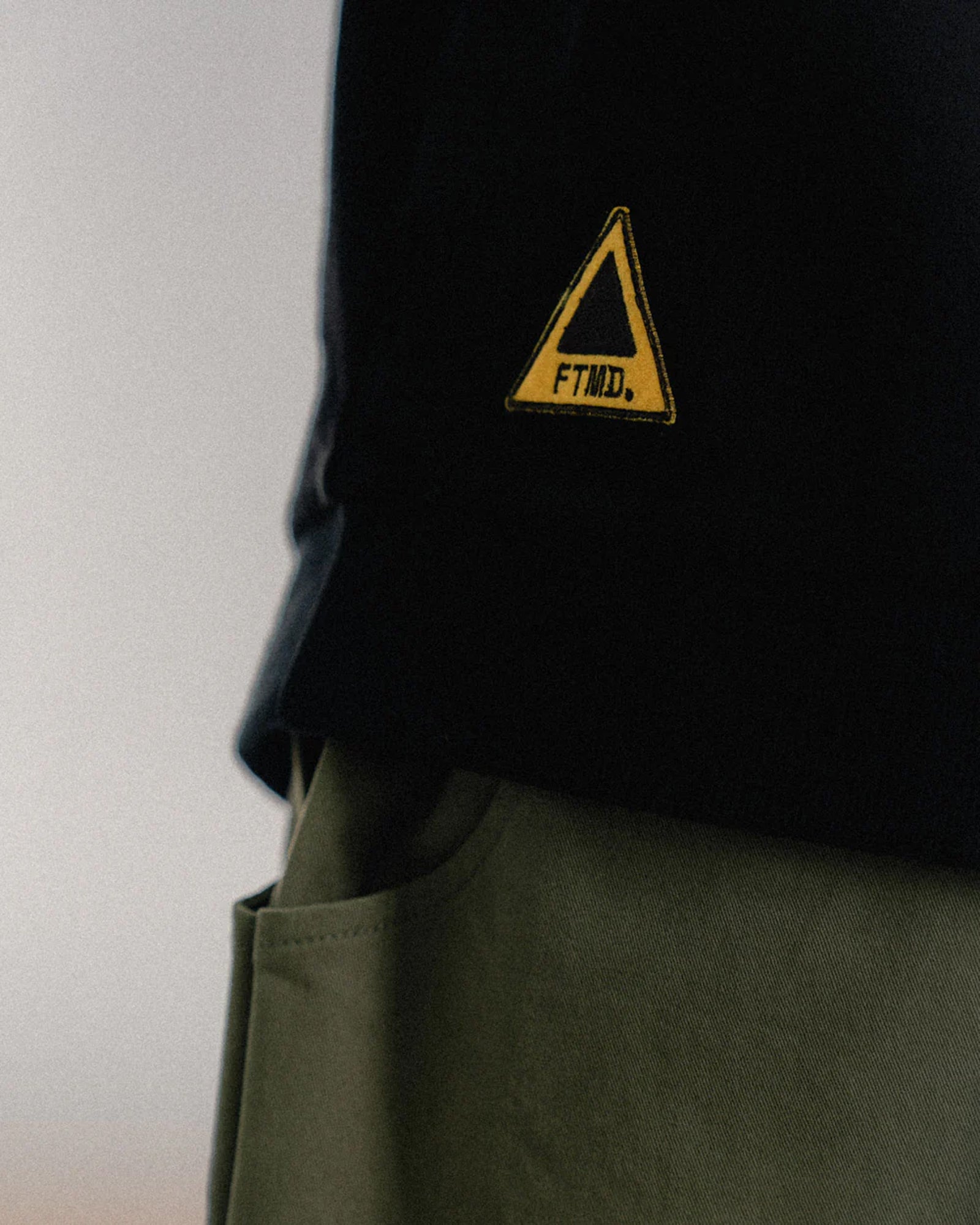 A Eckhaus Latta Shirt pictured on a model in front of a white background. The title of the product is Eckhaus Latta Eclipse Turtleneck - Stone and the image was taken by 199A®.