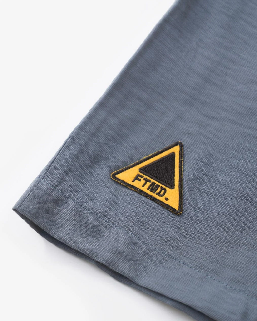 A Eckhaus Latta Shirt pictured on a model in front of a white background. The title of the product is Eckhaus Latta Eclipse Turtleneck - Stone and the image was taken by 199A®.