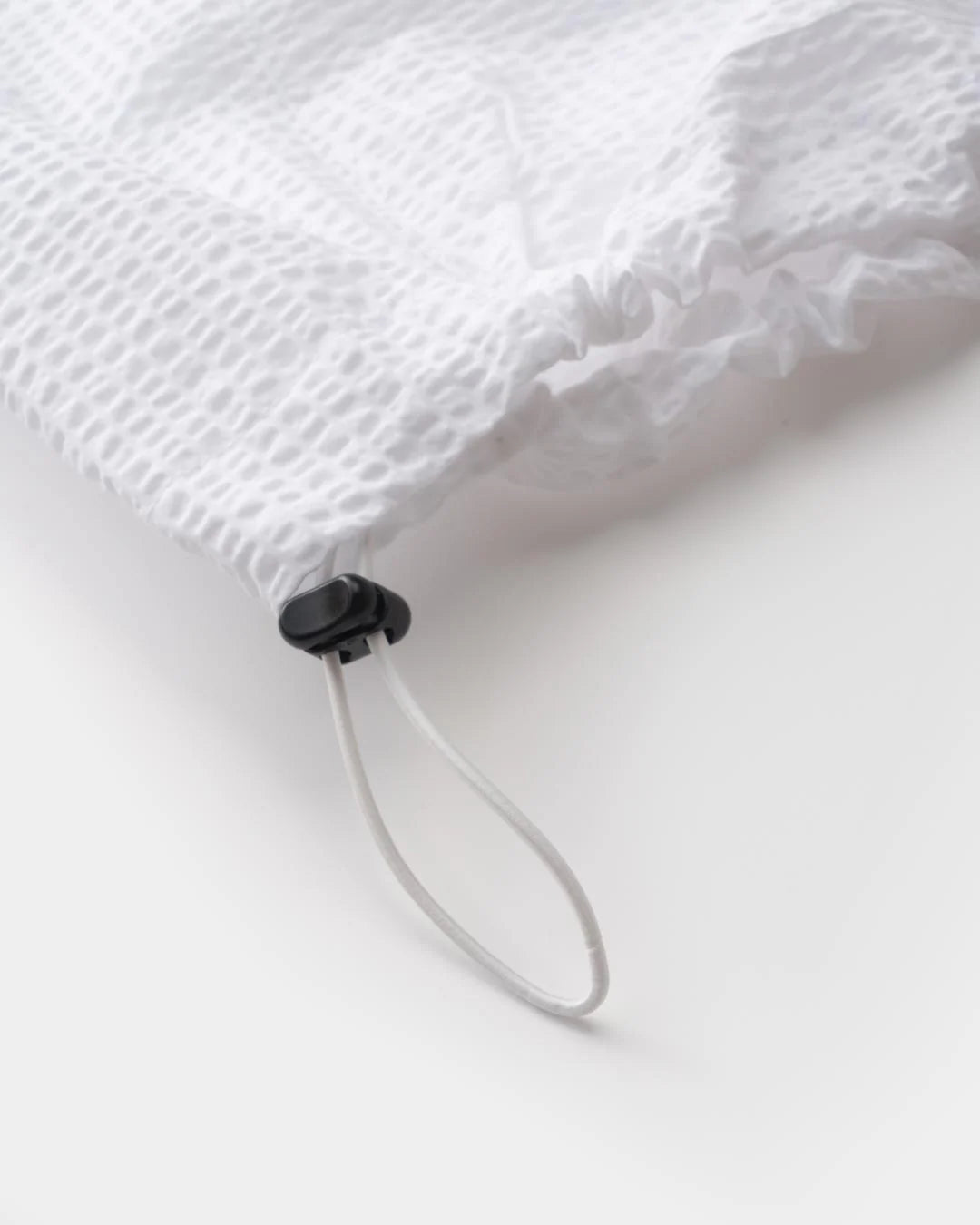 A Eckhaus Latta Shirt pictured on a model in front of a white background. The title of the product is Eckhaus Latta Eclipse Turtleneck - Stone and the image was taken by 199A®.