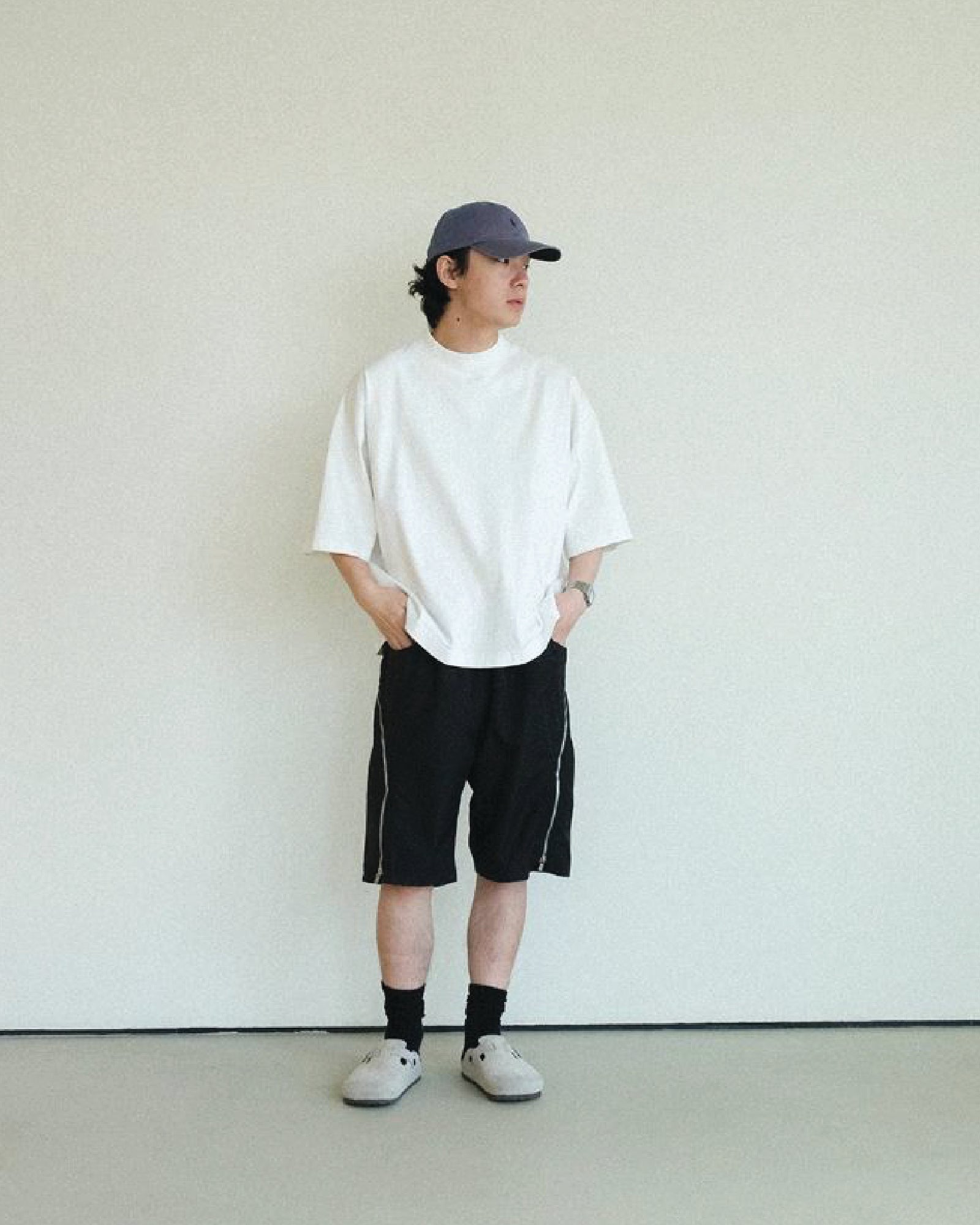 A Eckhaus Latta Shirt pictured on a model in front of a white background. The title of the product is Eckhaus Latta Eclipse Turtleneck - Stone and the image was taken by 199A®.