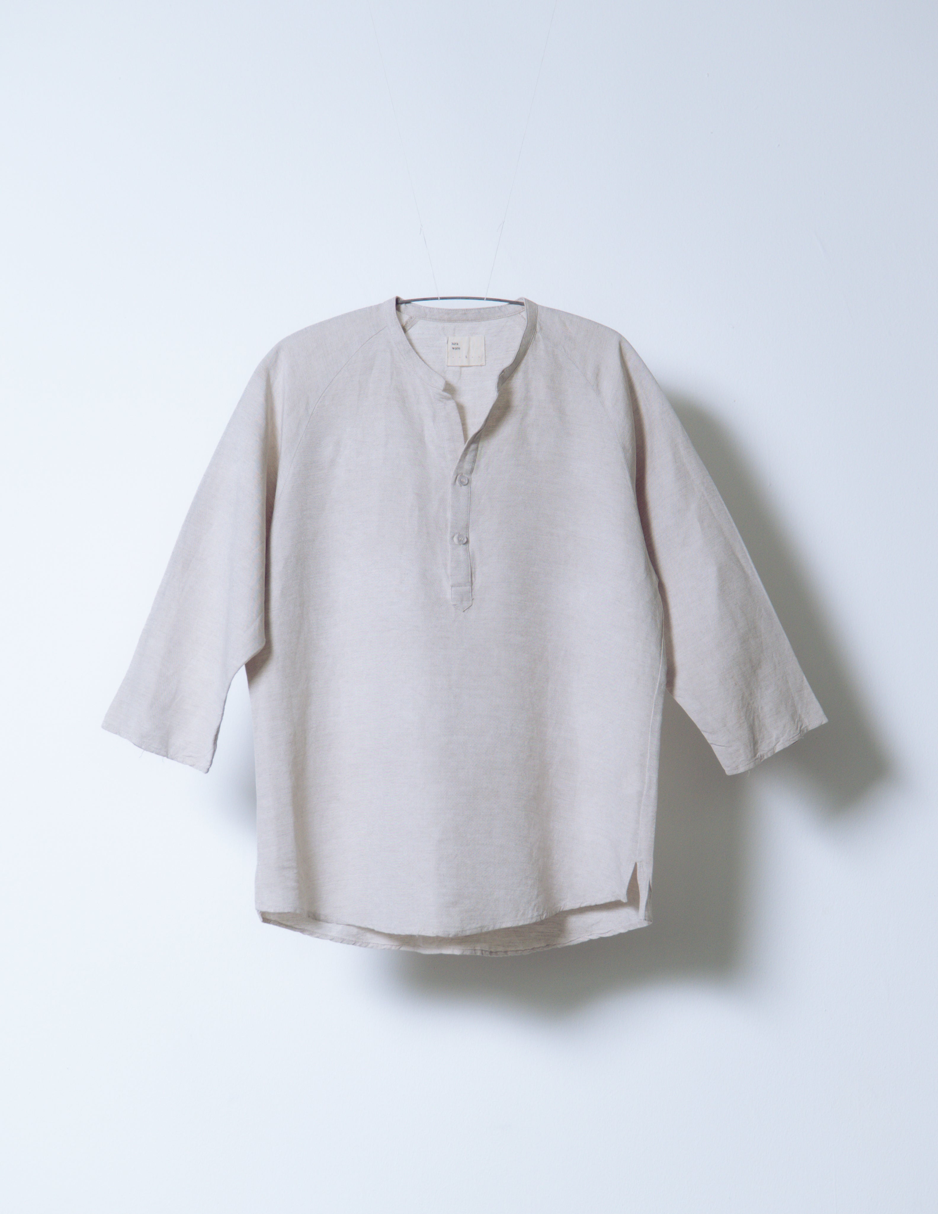 A Eckhaus Latta Shirt pictured on a model in front of a white background. The title of the product is Eckhaus Latta Eclipse Turtleneck - Stone and the image was taken by 199A®.