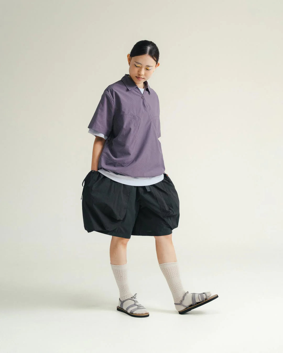 A Eckhaus Latta Shirt pictured on a model in front of a white background. The title of the product is Eckhaus Latta Eclipse Turtleneck - Stone and the image was taken by 199A®.