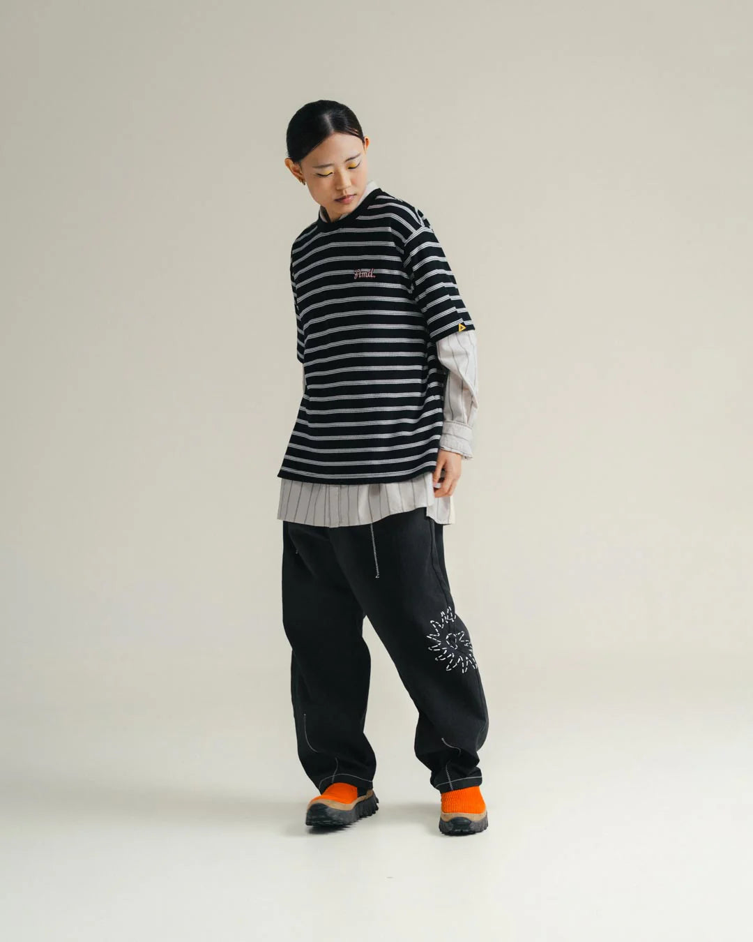 A Eckhaus Latta Shirt pictured on a model in front of a white background. The title of the product is Eckhaus Latta Eclipse Turtleneck - Stone and the image was taken by 199A®.