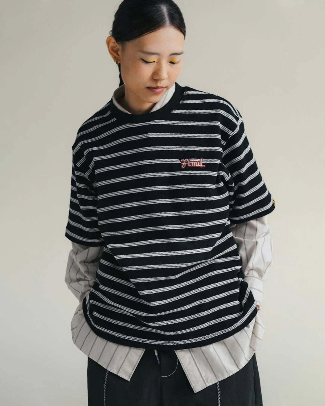 A Eckhaus Latta Shirt pictured on a model in front of a white background. The title of the product is Eckhaus Latta Eclipse Turtleneck - Stone and the image was taken by 199A®.