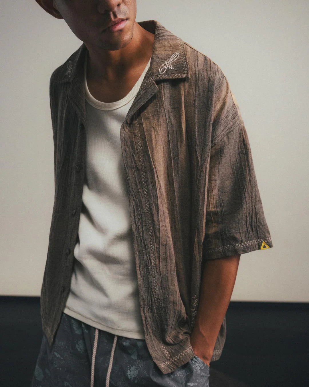 A Eckhaus Latta Shirt pictured on a model in front of a white background. The title of the product is Eckhaus Latta Eclipse Turtleneck - Stone and the image was taken by 199A®.