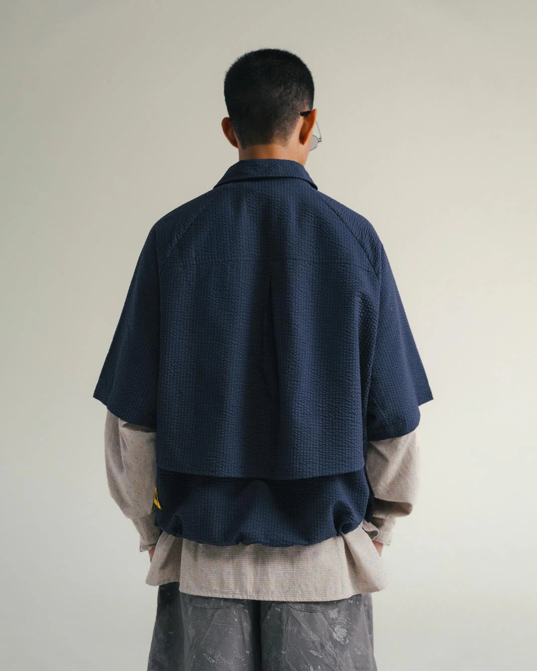 A Eckhaus Latta Shirt pictured on a model in front of a white background. The title of the product is Eckhaus Latta Eclipse Turtleneck - Stone and the image was taken by 199A®.