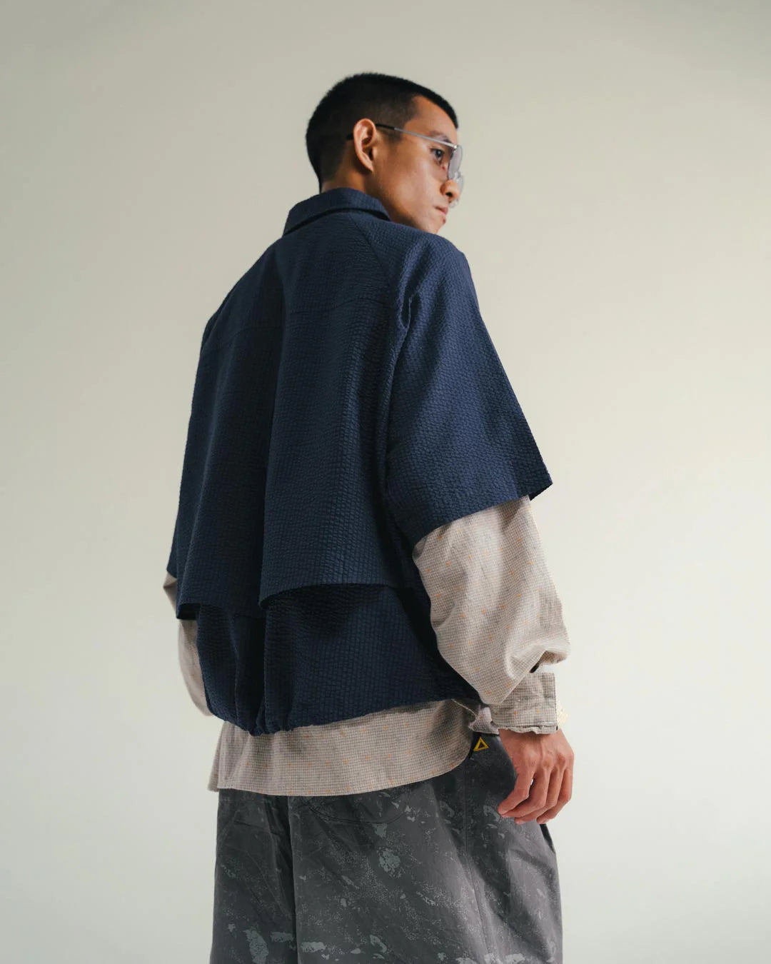 A Eckhaus Latta Shirt pictured on a model in front of a white background. The title of the product is Eckhaus Latta Eclipse Turtleneck - Stone and the image was taken by 199A®.