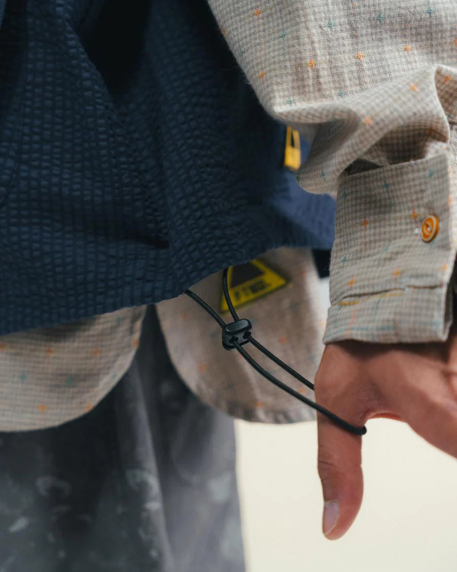 A Eckhaus Latta Shirt pictured on a model in front of a white background. The title of the product is Eckhaus Latta Eclipse Turtleneck - Stone and the image was taken by 199A®.