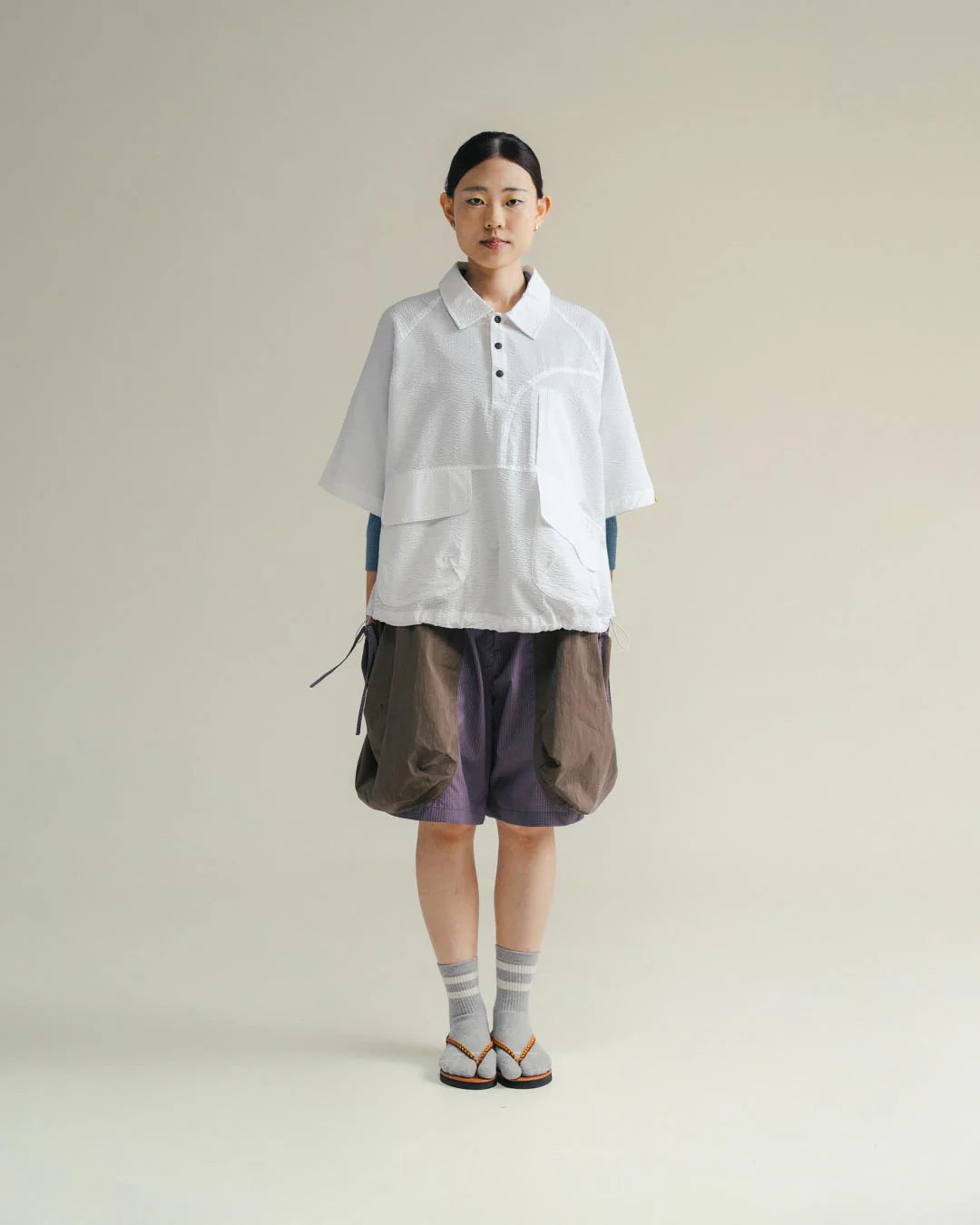 A Eckhaus Latta Shirt pictured on a model in front of a white background. The title of the product is Eckhaus Latta Eclipse Turtleneck - Stone and the image was taken by 199A®.