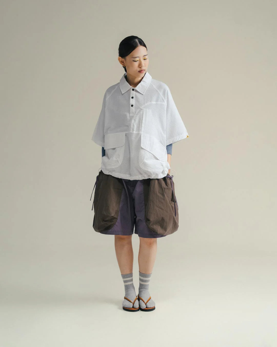 A Eckhaus Latta Shirt pictured on a model in front of a white background. The title of the product is Eckhaus Latta Eclipse Turtleneck - Stone and the image was taken by 199A®.