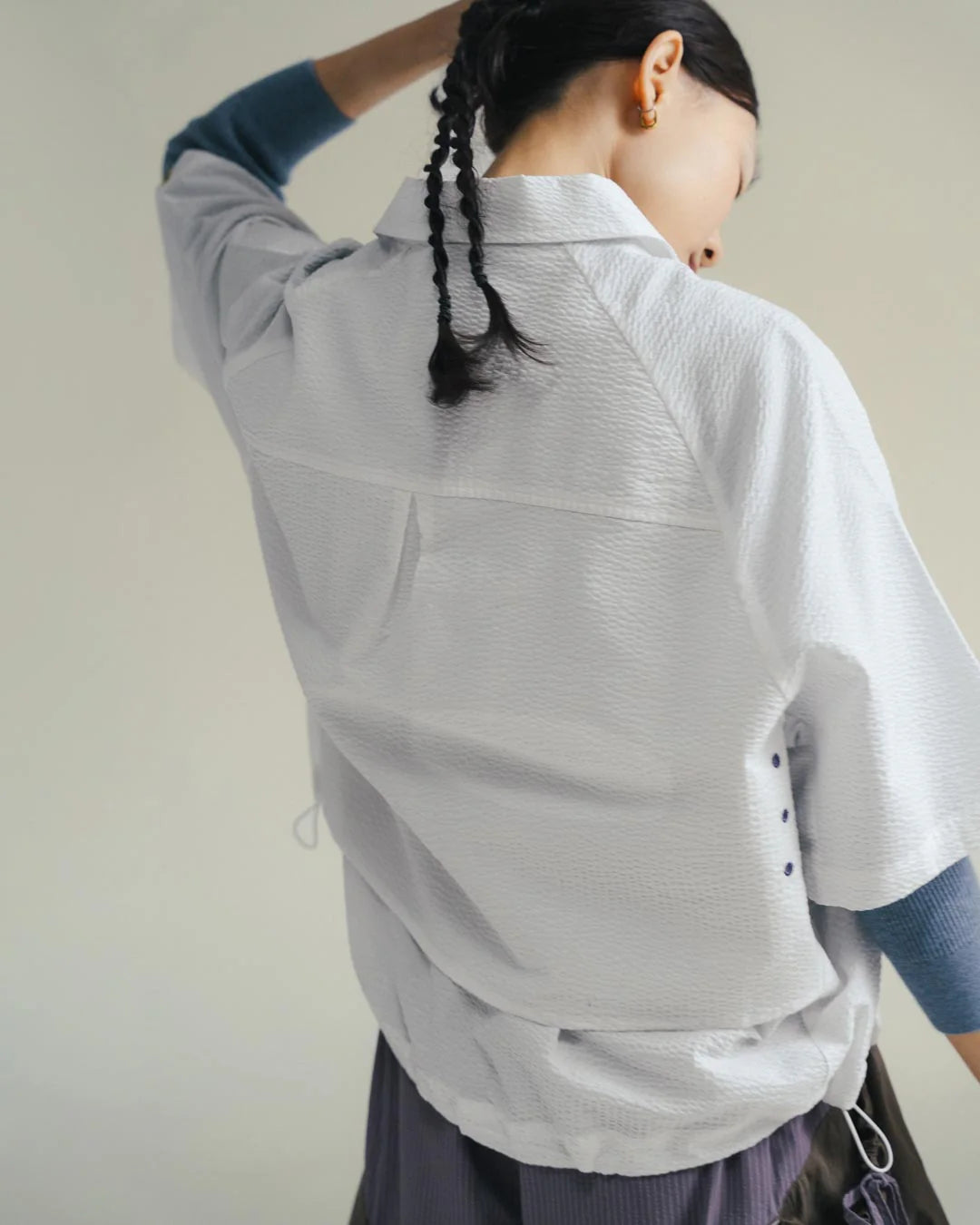 A Eckhaus Latta Shirt pictured on a model in front of a white background. The title of the product is Eckhaus Latta Eclipse Turtleneck - Stone and the image was taken by 199A®.