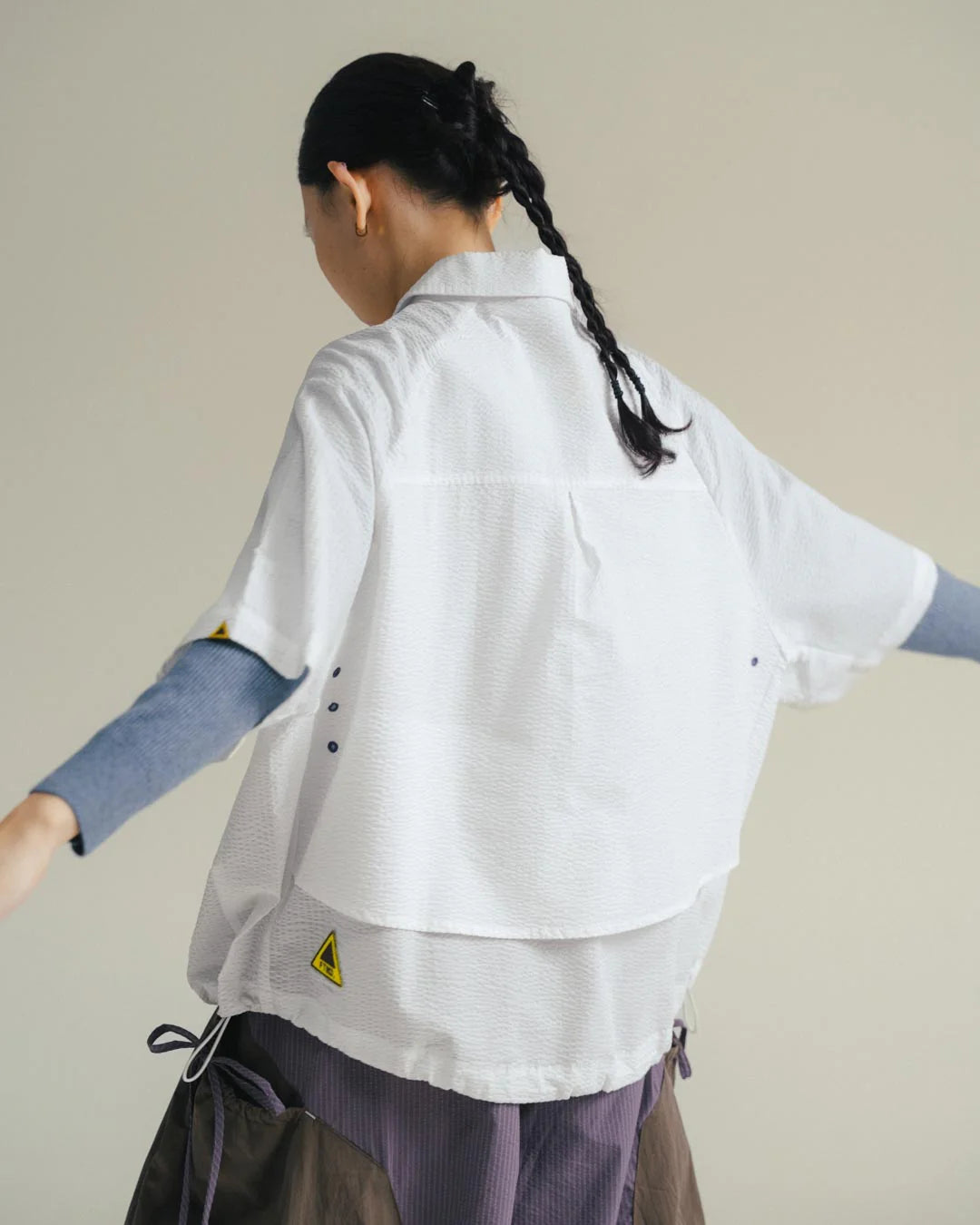 A Eckhaus Latta Shirt pictured on a model in front of a white background. The title of the product is Eckhaus Latta Eclipse Turtleneck - Stone and the image was taken by 199A®.