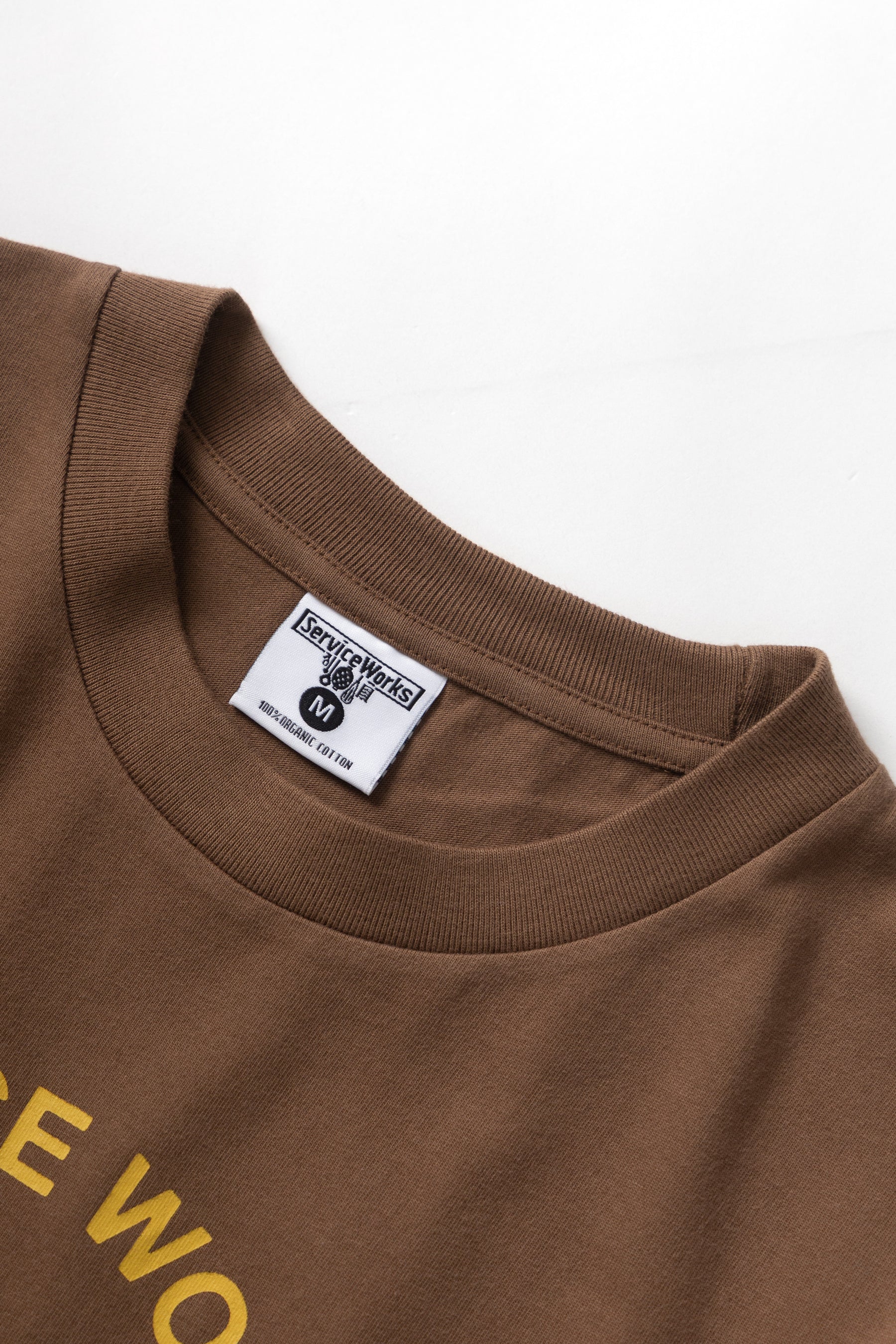 A Eckhaus Latta Shirt pictured on a model in front of a white background. The title of the product is Eckhaus Latta Eclipse Turtleneck - Stone and the image was taken by 199A®.