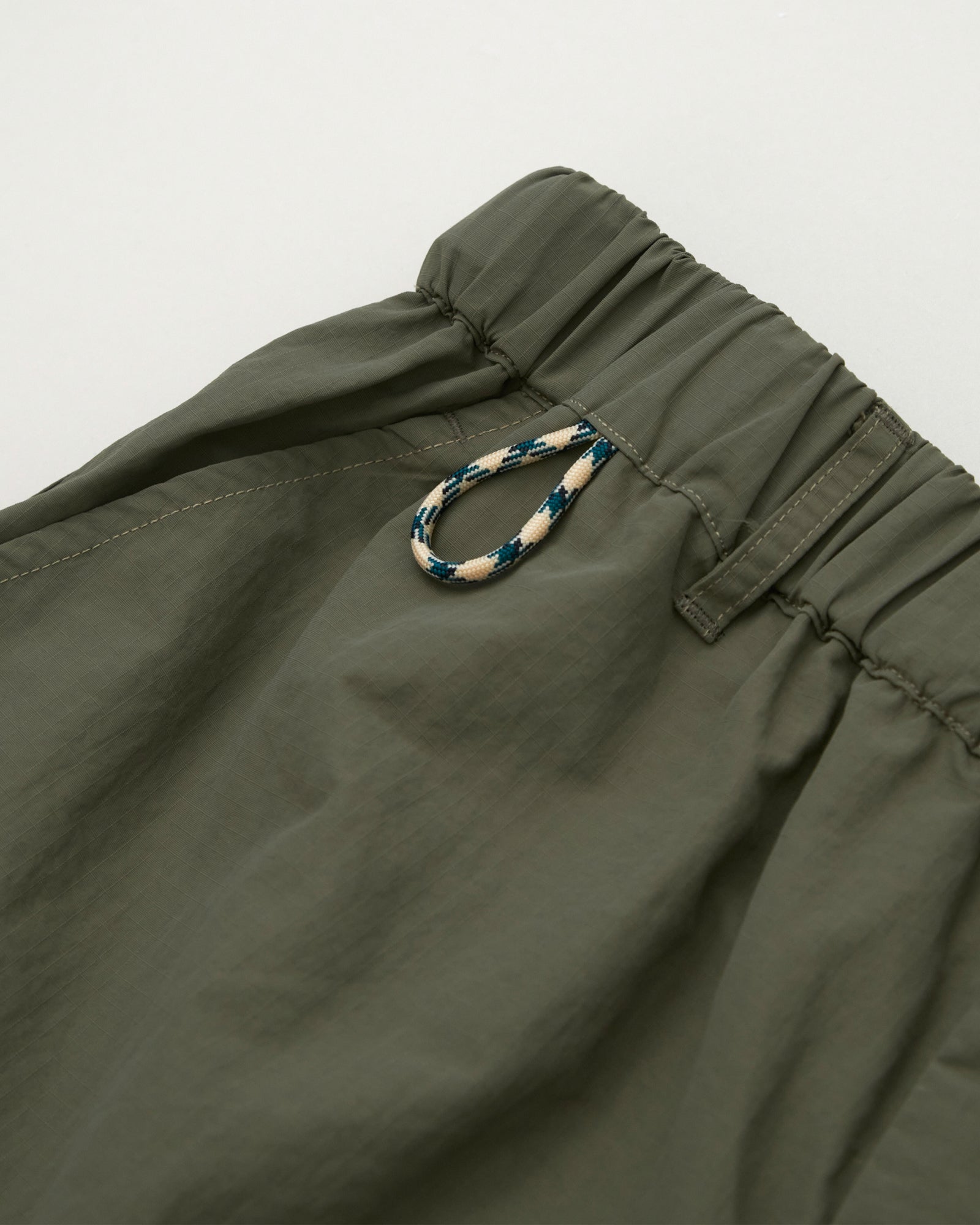 A Eckhaus Latta Shirt pictured on a model in front of a white background. The title of the product is Eckhaus Latta Eclipse Turtleneck - Stone and the image was taken by 199A®.