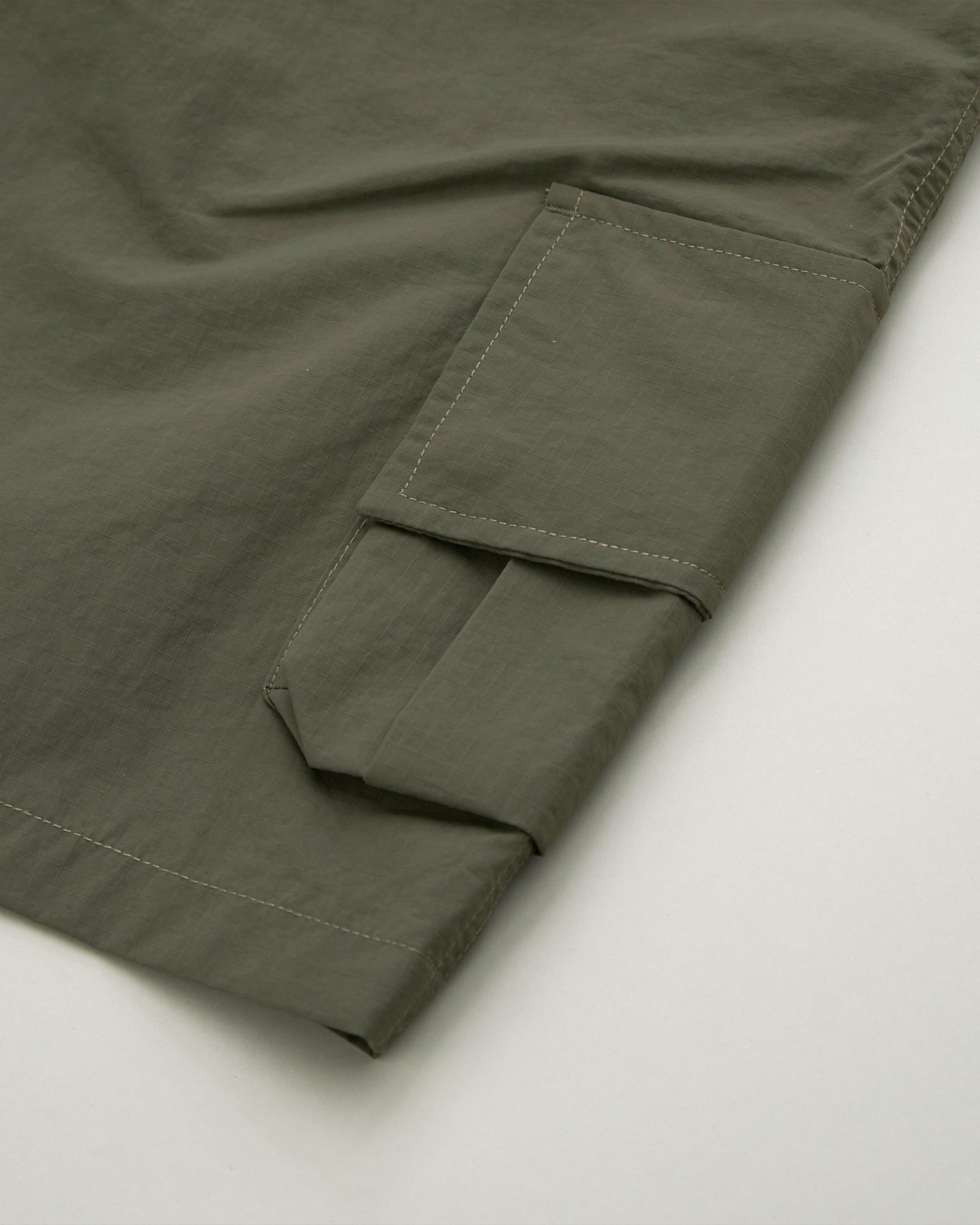 A Eckhaus Latta Shirt pictured on a model in front of a white background. The title of the product is Eckhaus Latta Eclipse Turtleneck - Stone and the image was taken by 199A®.