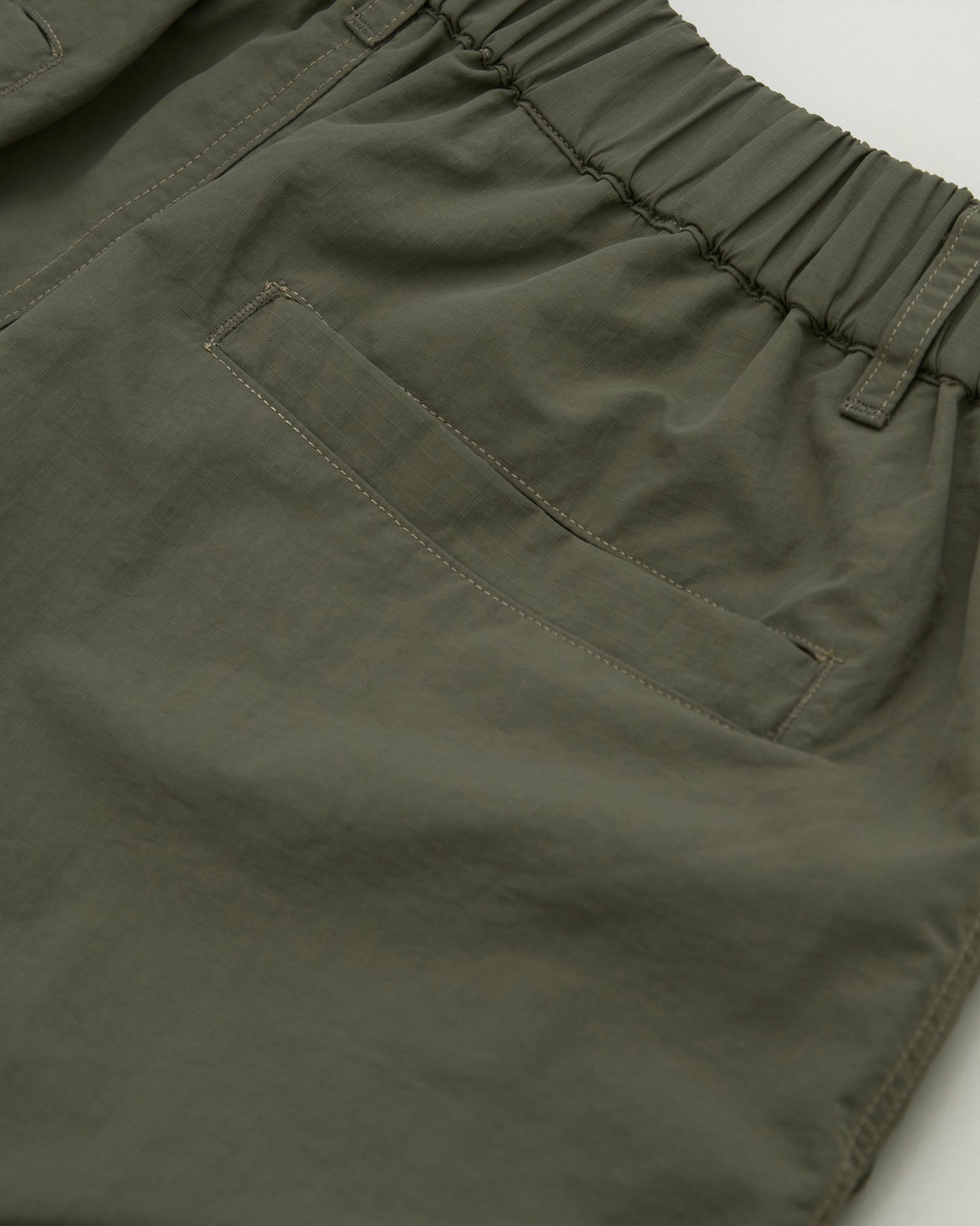 A Eckhaus Latta Shirt pictured on a model in front of a white background. The title of the product is Eckhaus Latta Eclipse Turtleneck - Stone and the image was taken by 199A®.