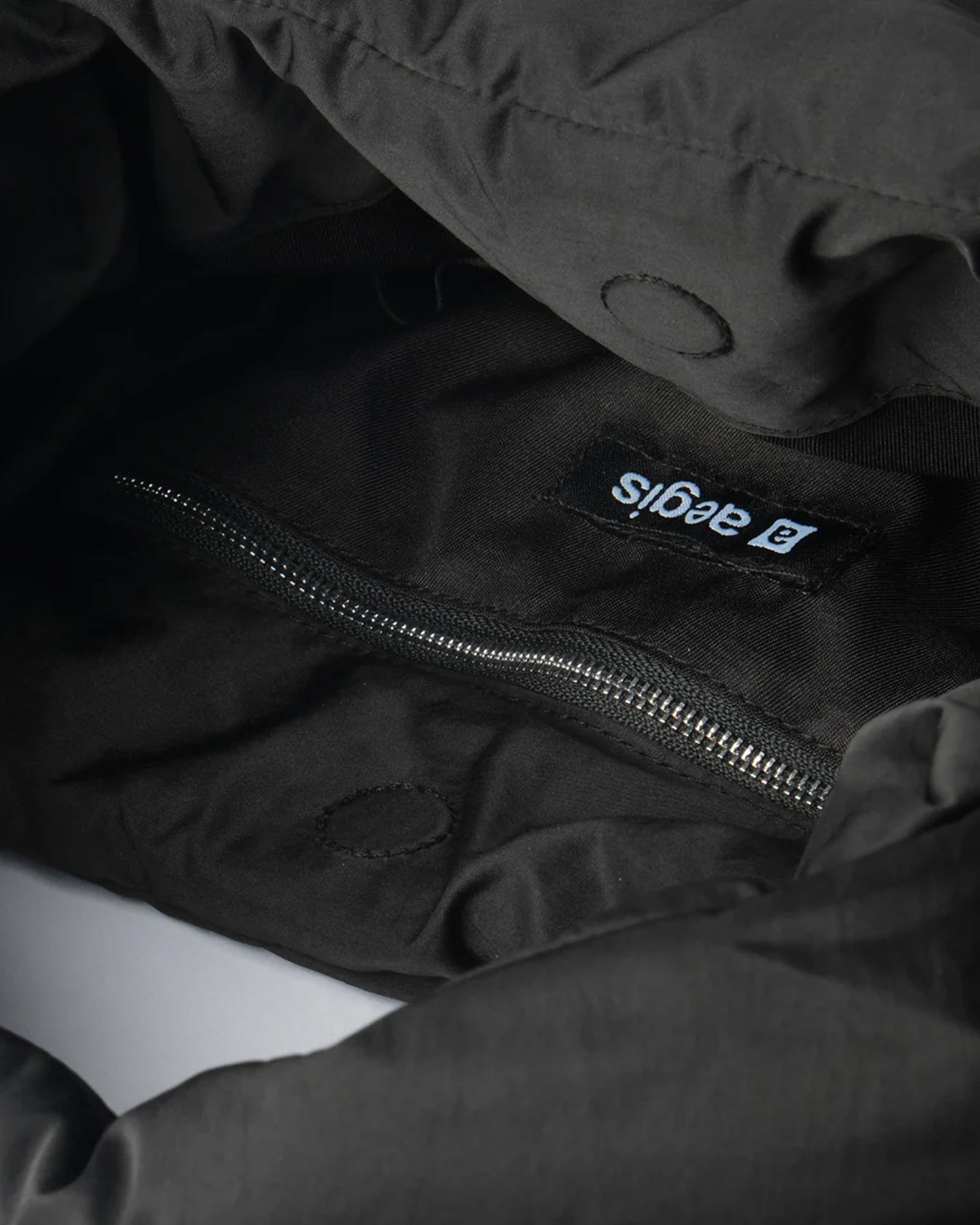 A Eckhaus Latta Shirt pictured on a model in front of a white background. The title of the product is Eckhaus Latta Eclipse Turtleneck - Stone and the image was taken by 199A®.