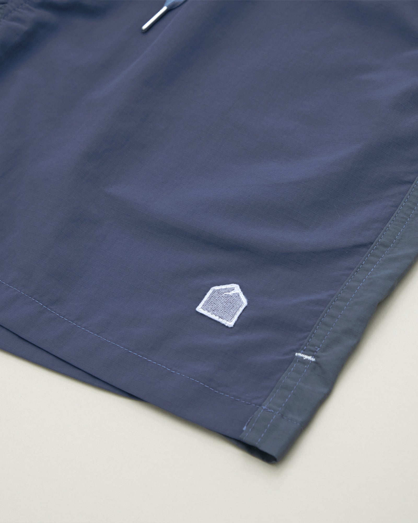 A Eckhaus Latta Shirt pictured on a model in front of a white background. The title of the product is Eckhaus Latta Eclipse Turtleneck - Stone and the image was taken by 199A®.