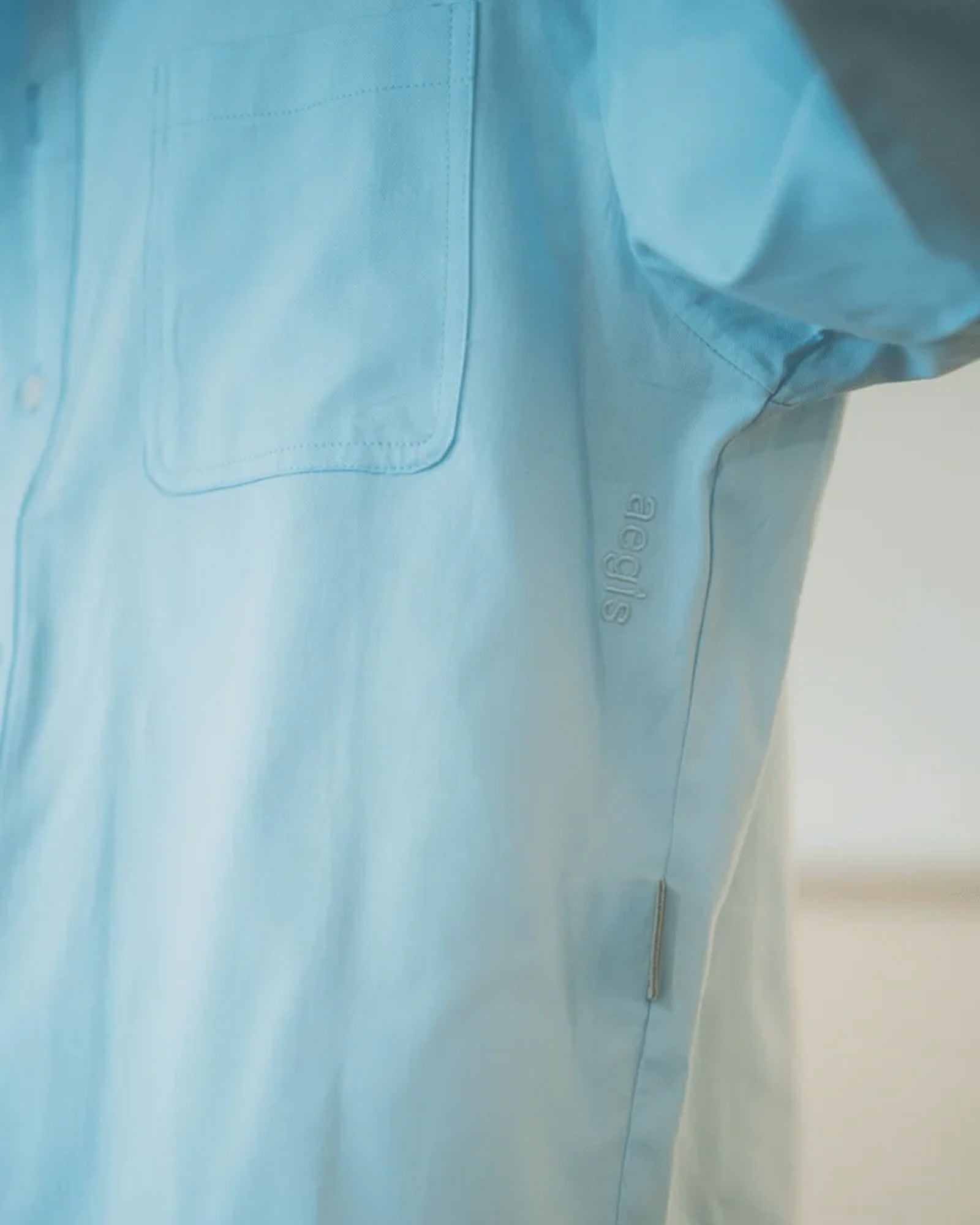 A Eckhaus Latta Shirt pictured on a model in front of a white background. The title of the product is Eckhaus Latta Eclipse Turtleneck - Stone and the image was taken by 199A®.
