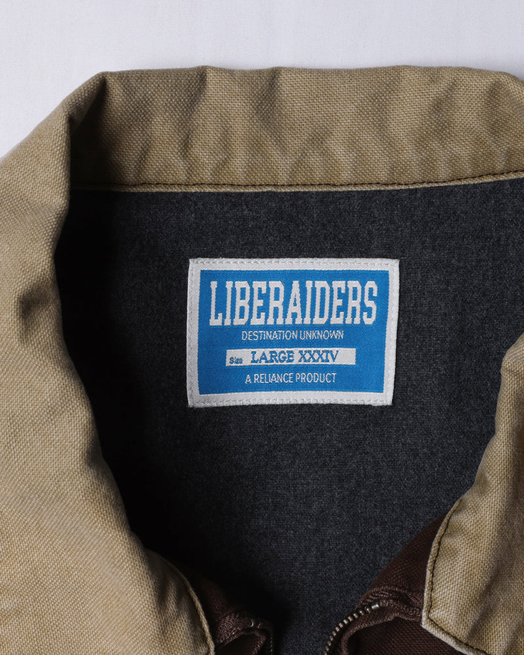 A Eckhaus Latta Shirt pictured on a model in front of a white background. The title of the product is Eckhaus Latta Eclipse Turtleneck - Stone and the image was taken by 199A®.