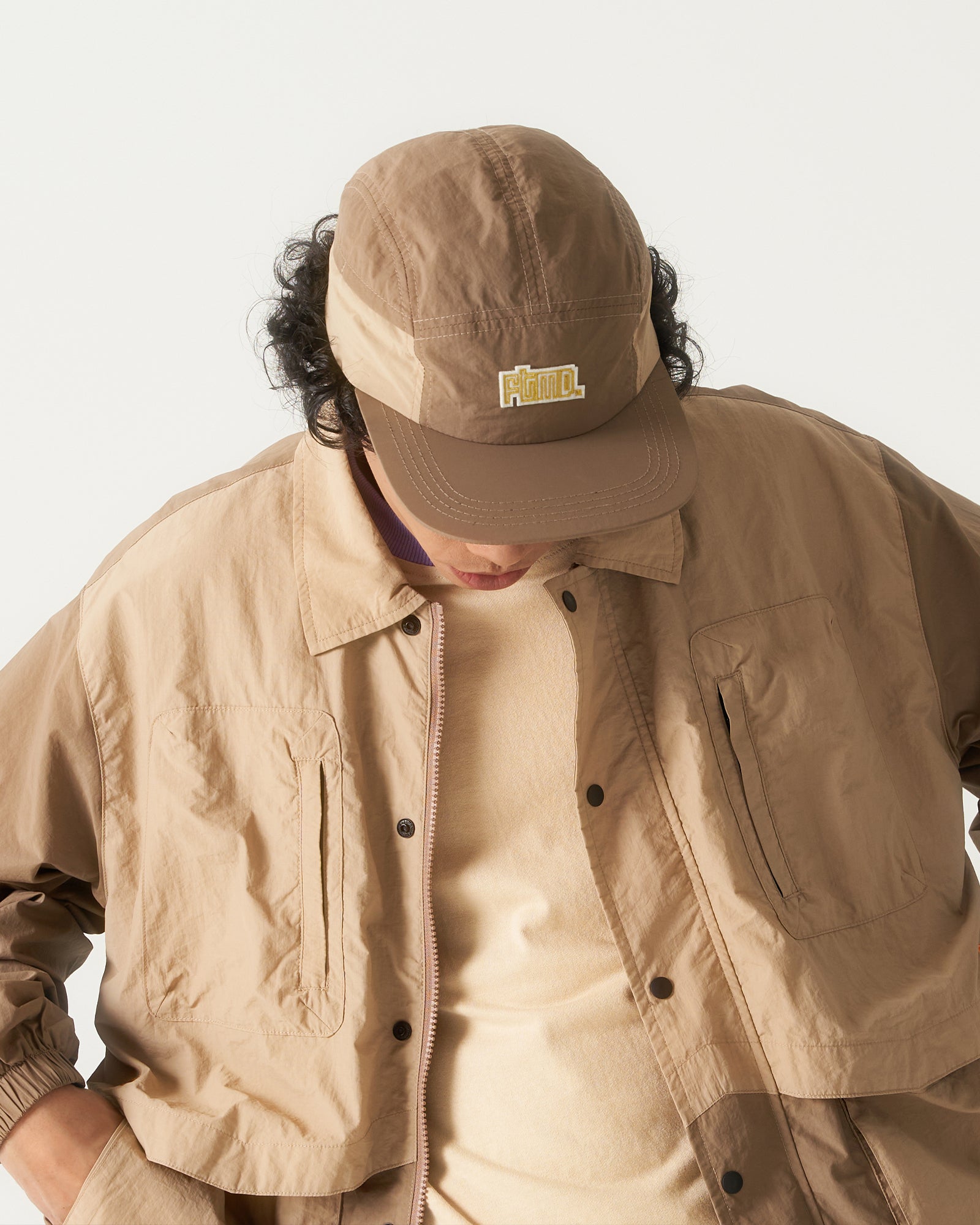 A Eckhaus Latta Shirt pictured on a model in front of a white background. The title of the product is Eckhaus Latta Eclipse Turtleneck - Stone and the image was taken by 199A®.