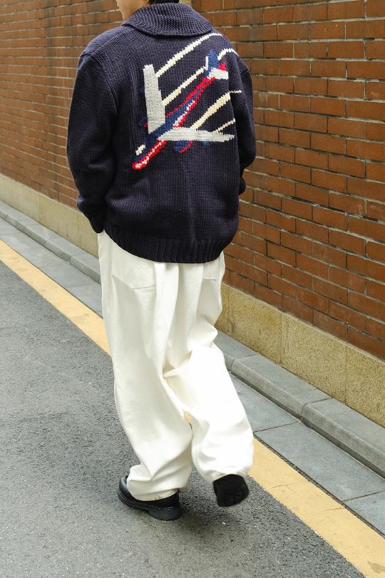 A Eckhaus Latta Shirt pictured on a model in front of a white background. The title of the product is Eckhaus Latta Eclipse Turtleneck - Stone and the image was taken by 199A®.