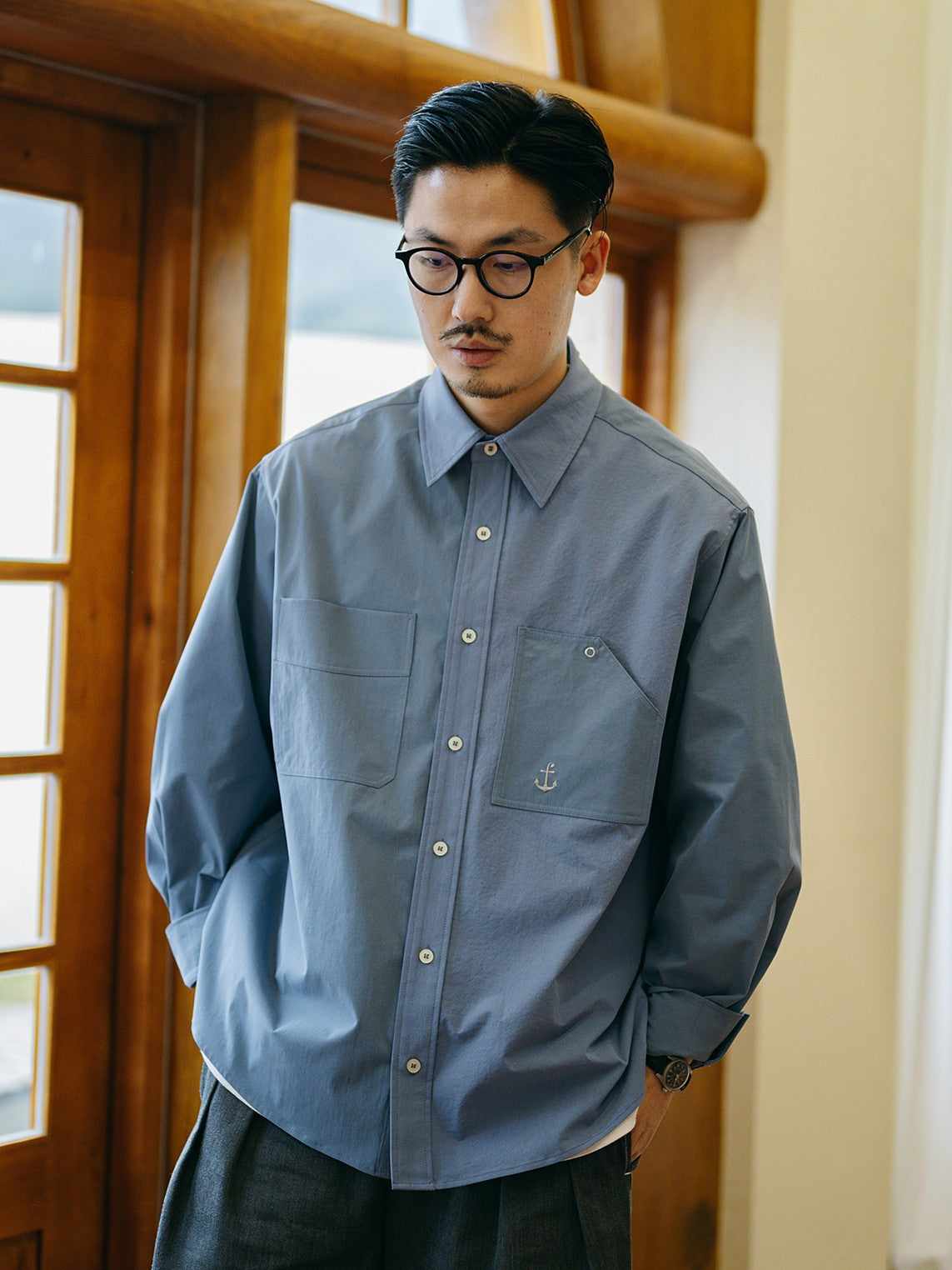 A Eckhaus Latta Shirt pictured on a model in front of a white background. The title of the product is Eckhaus Latta Eclipse Turtleneck - Stone and the image was taken by 199A®.
