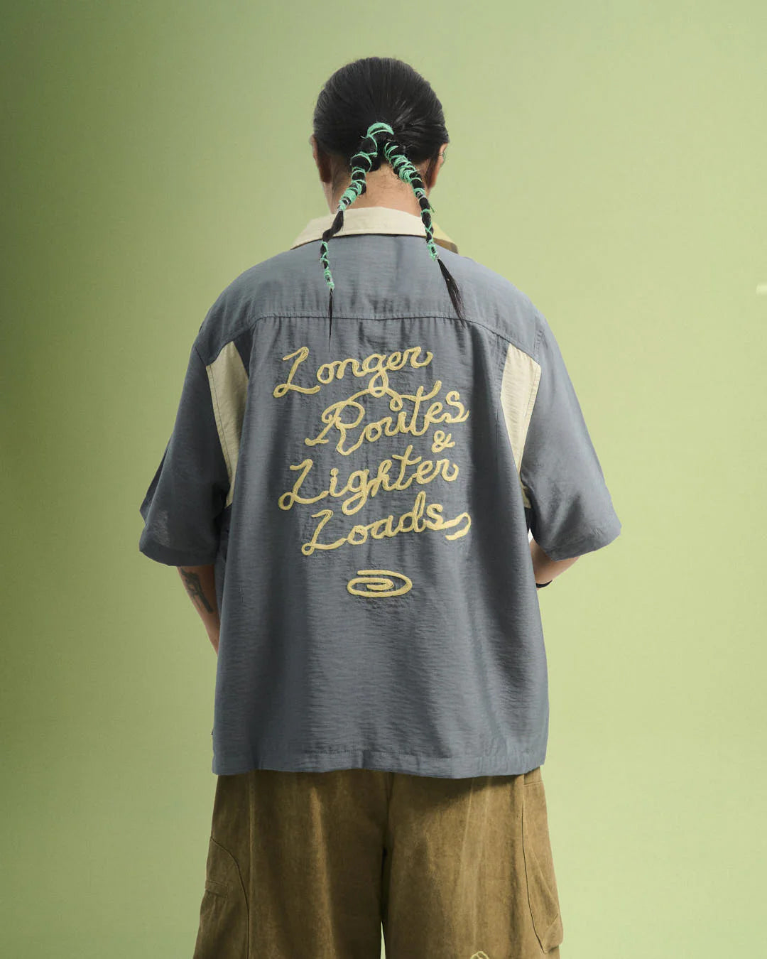 A Eckhaus Latta Shirt pictured on a model in front of a white background. The title of the product is Eckhaus Latta Eclipse Turtleneck - Stone and the image was taken by 199A®.