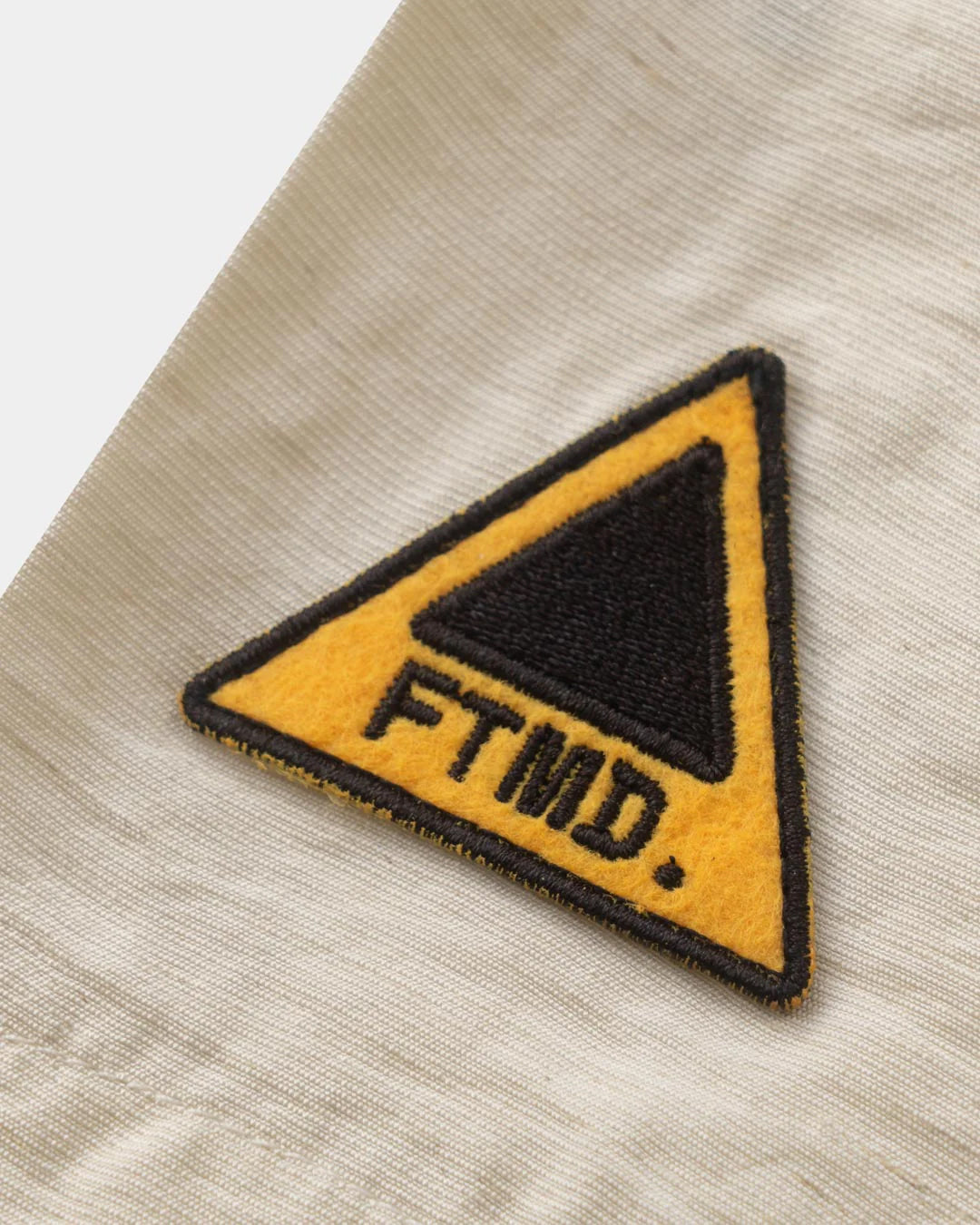 A Eckhaus Latta Shirt pictured on a model in front of a white background. The title of the product is Eckhaus Latta Eclipse Turtleneck - Stone and the image was taken by 199A®.