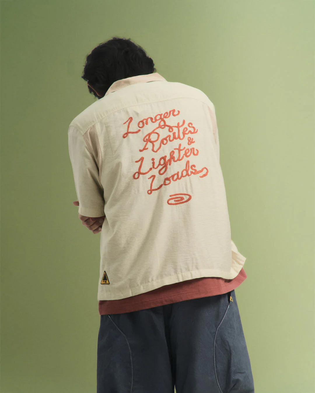 A Eckhaus Latta Shirt pictured on a model in front of a white background. The title of the product is Eckhaus Latta Eclipse Turtleneck - Stone and the image was taken by 199A®.