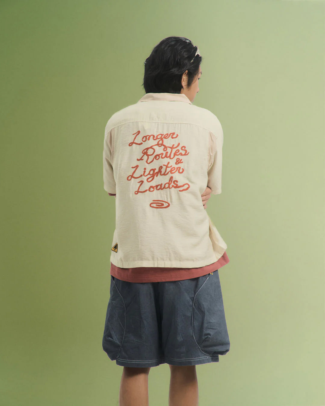 A Eckhaus Latta Shirt pictured on a model in front of a white background. The title of the product is Eckhaus Latta Eclipse Turtleneck - Stone and the image was taken by 199A®.
