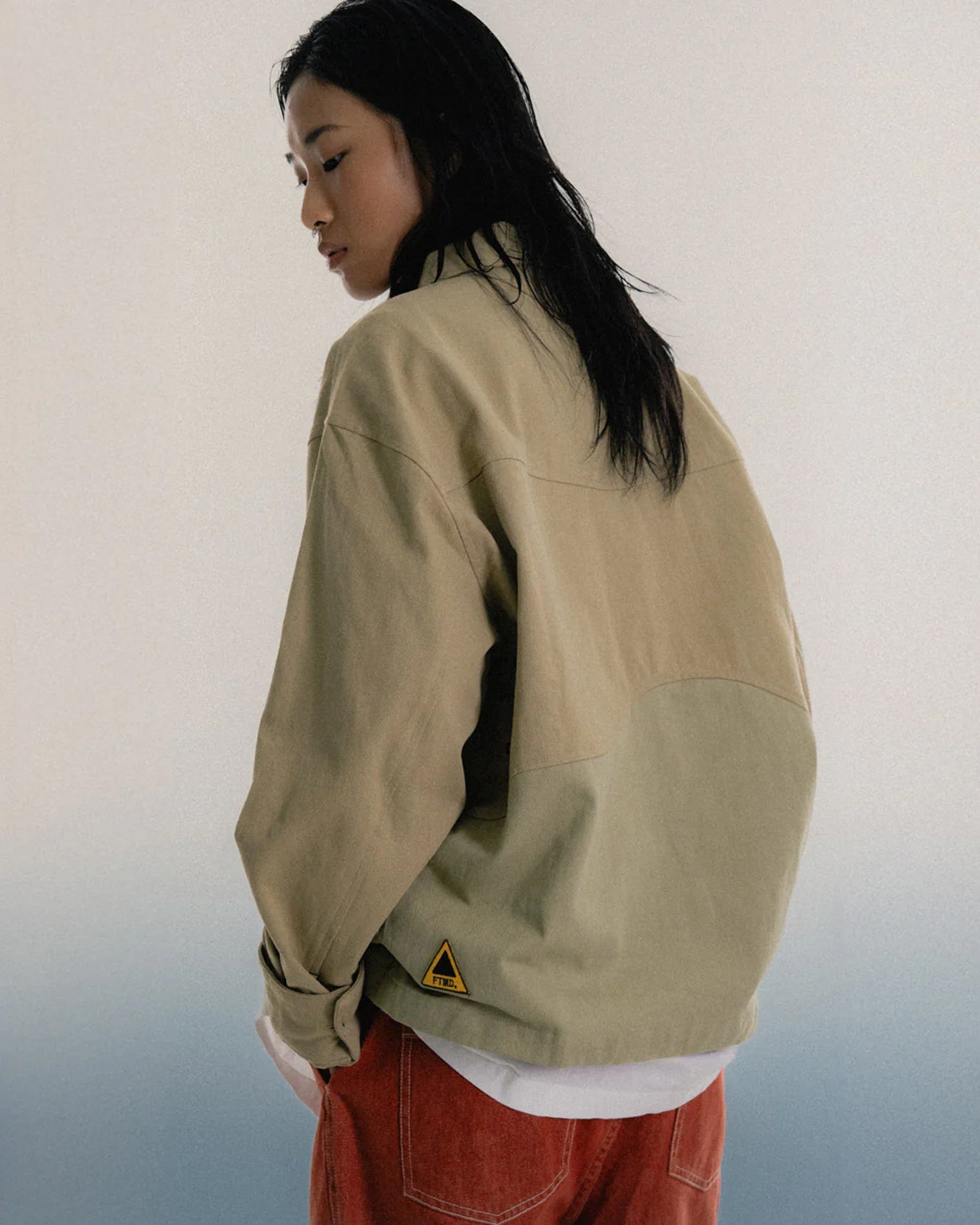 A Eckhaus Latta Shirt pictured on a model in front of a white background. The title of the product is Eckhaus Latta Eclipse Turtleneck - Stone and the image was taken by 199A®.