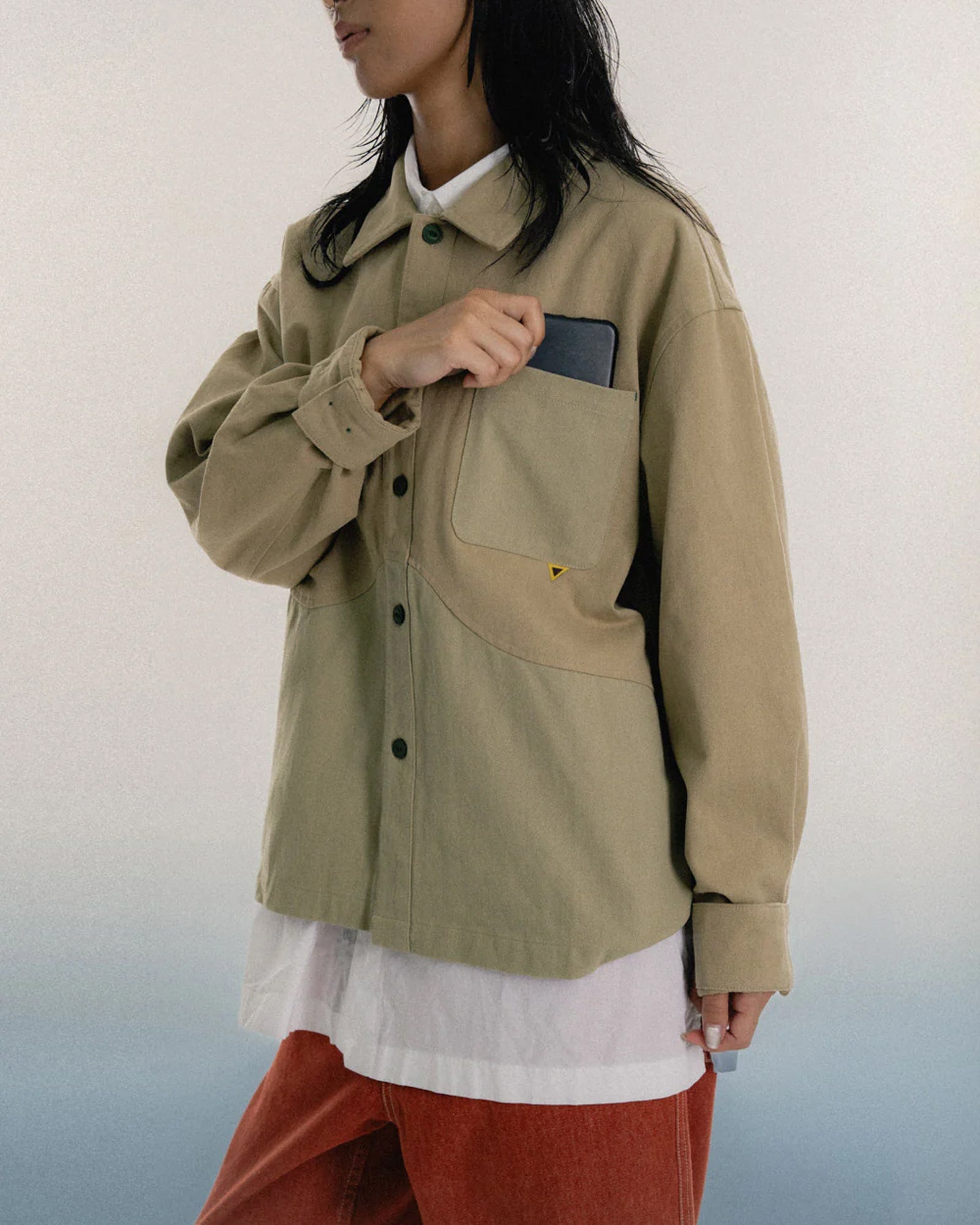 A Eckhaus Latta Shirt pictured on a model in front of a white background. The title of the product is Eckhaus Latta Eclipse Turtleneck - Stone and the image was taken by 199A®.