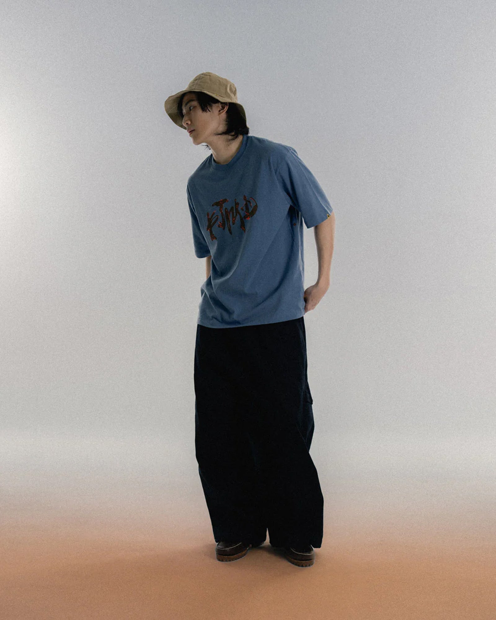 A Eckhaus Latta Shirt pictured on a model in front of a white background. The title of the product is Eckhaus Latta Eclipse Turtleneck - Stone and the image was taken by 199A®.