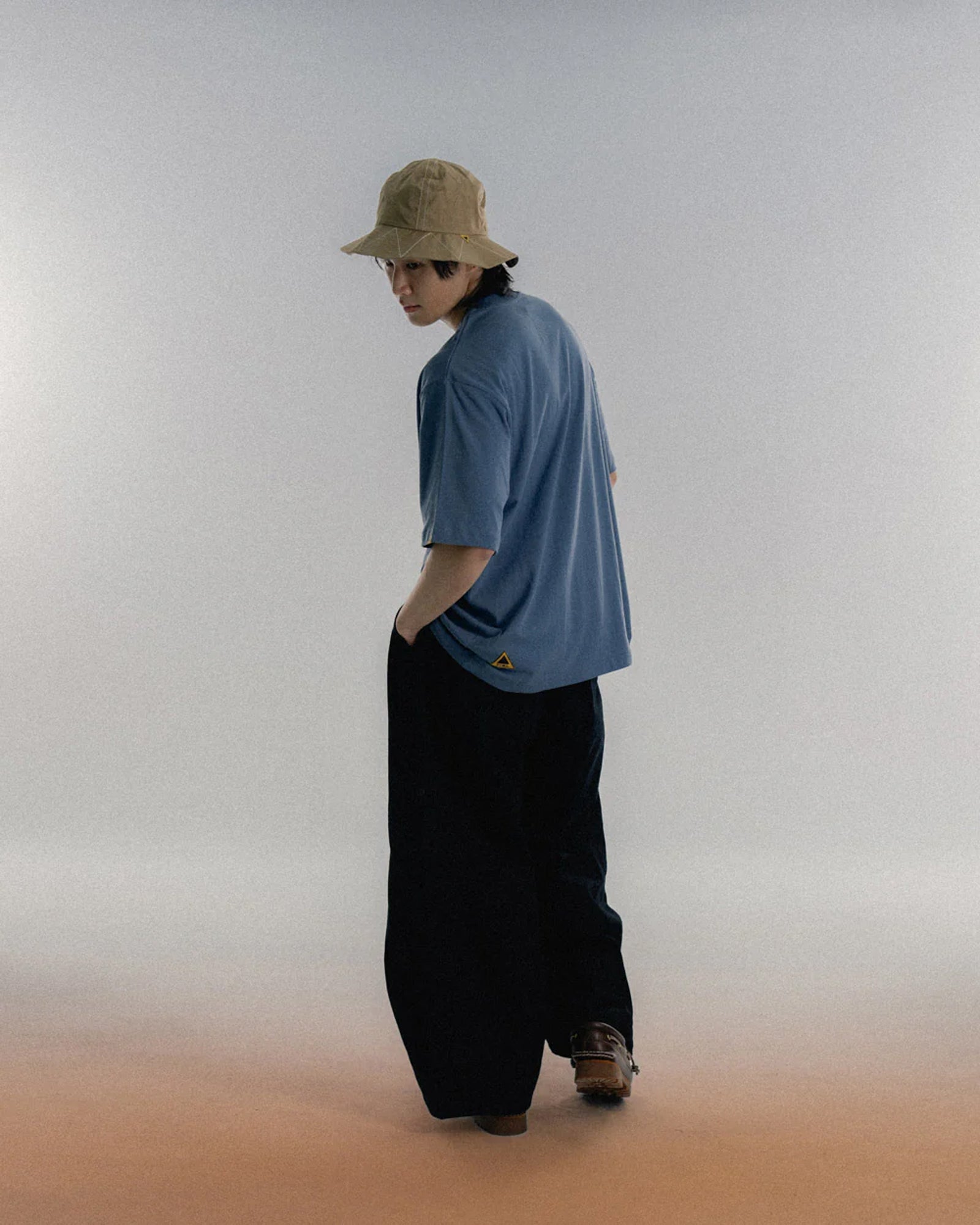 A Eckhaus Latta Shirt pictured on a model in front of a white background. The title of the product is Eckhaus Latta Eclipse Turtleneck - Stone and the image was taken by 199A®.