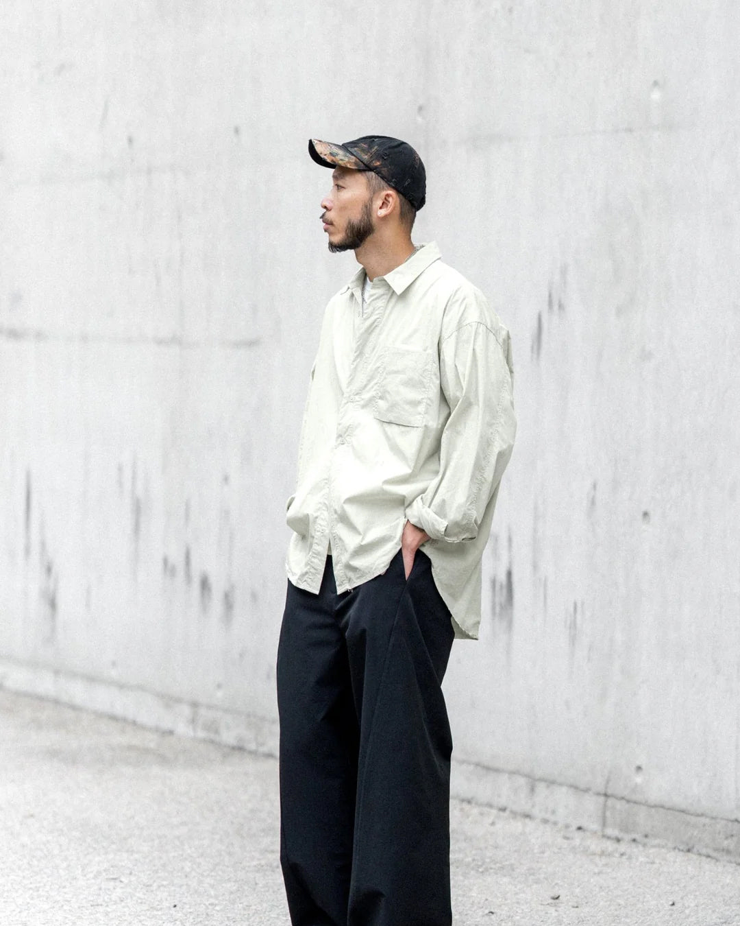 A Eckhaus Latta Shirt pictured on a model in front of a white background. The title of the product is Eckhaus Latta Eclipse Turtleneck - Stone and the image was taken by 199A®.