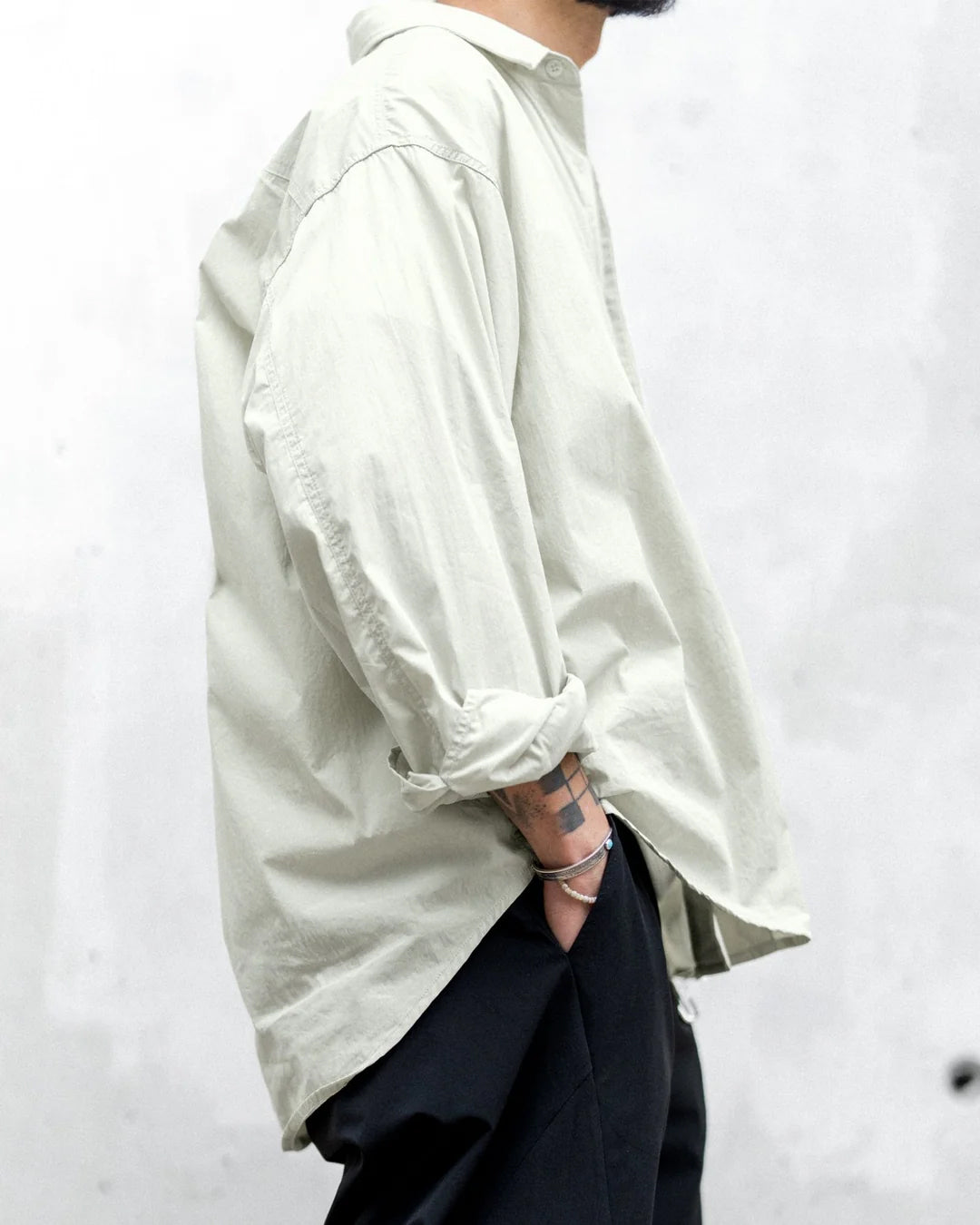 A Eckhaus Latta Shirt pictured on a model in front of a white background. The title of the product is Eckhaus Latta Eclipse Turtleneck - Stone and the image was taken by 199A®.