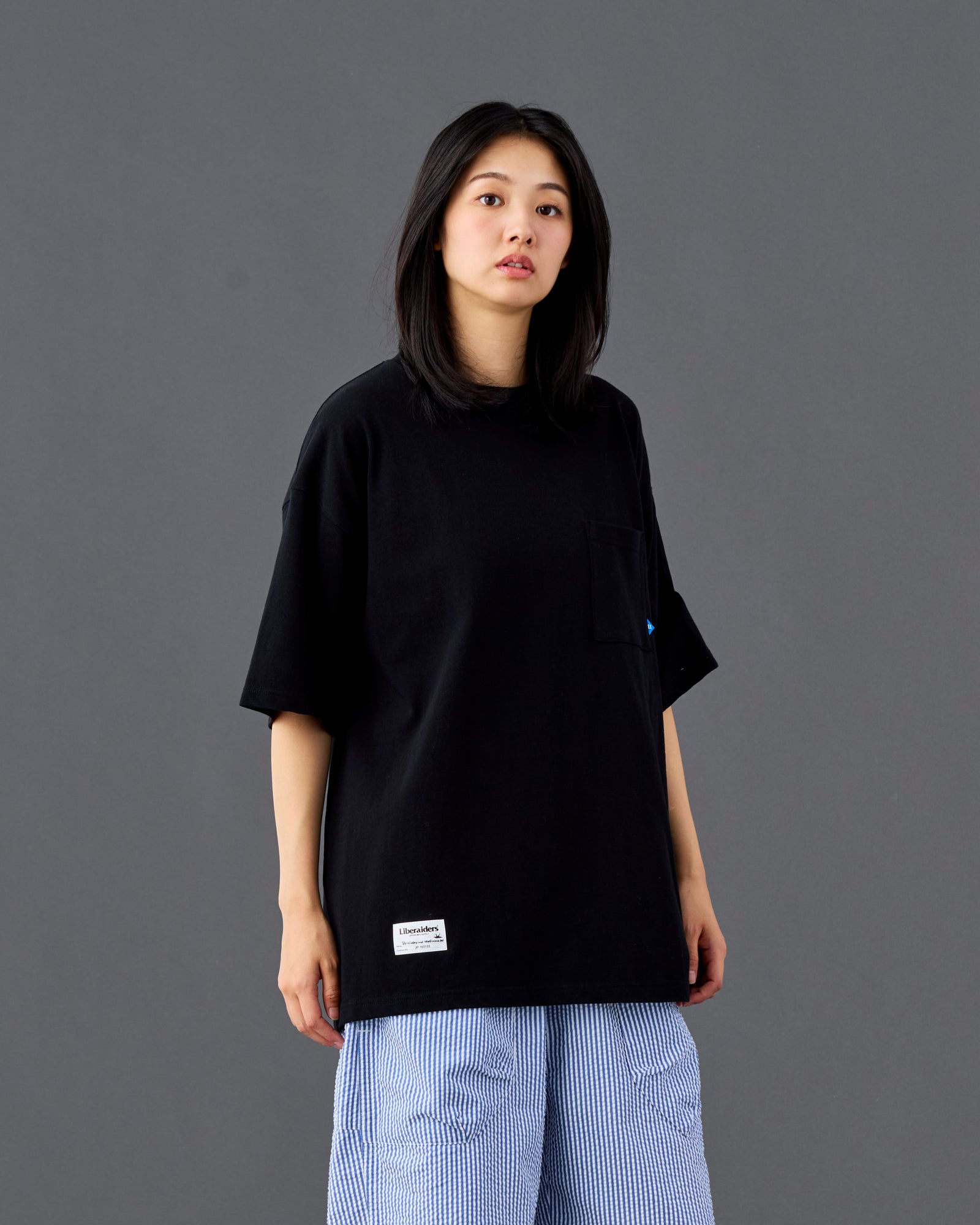 A Eckhaus Latta Shirt pictured on a model in front of a white background. The title of the product is Eckhaus Latta Eclipse Turtleneck - Stone and the image was taken by 199A®.