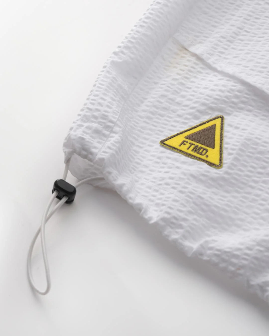 A Eckhaus Latta Shirt pictured on a model in front of a white background. The title of the product is Eckhaus Latta Eclipse Turtleneck - Stone and the image was taken by 199A®.