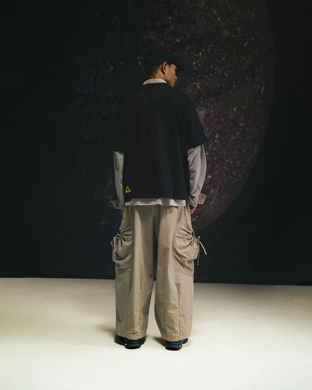 A Eckhaus Latta Shirt pictured on a model in front of a white background. The title of the product is Eckhaus Latta Eclipse Turtleneck - Stone and the image was taken by 199A®.