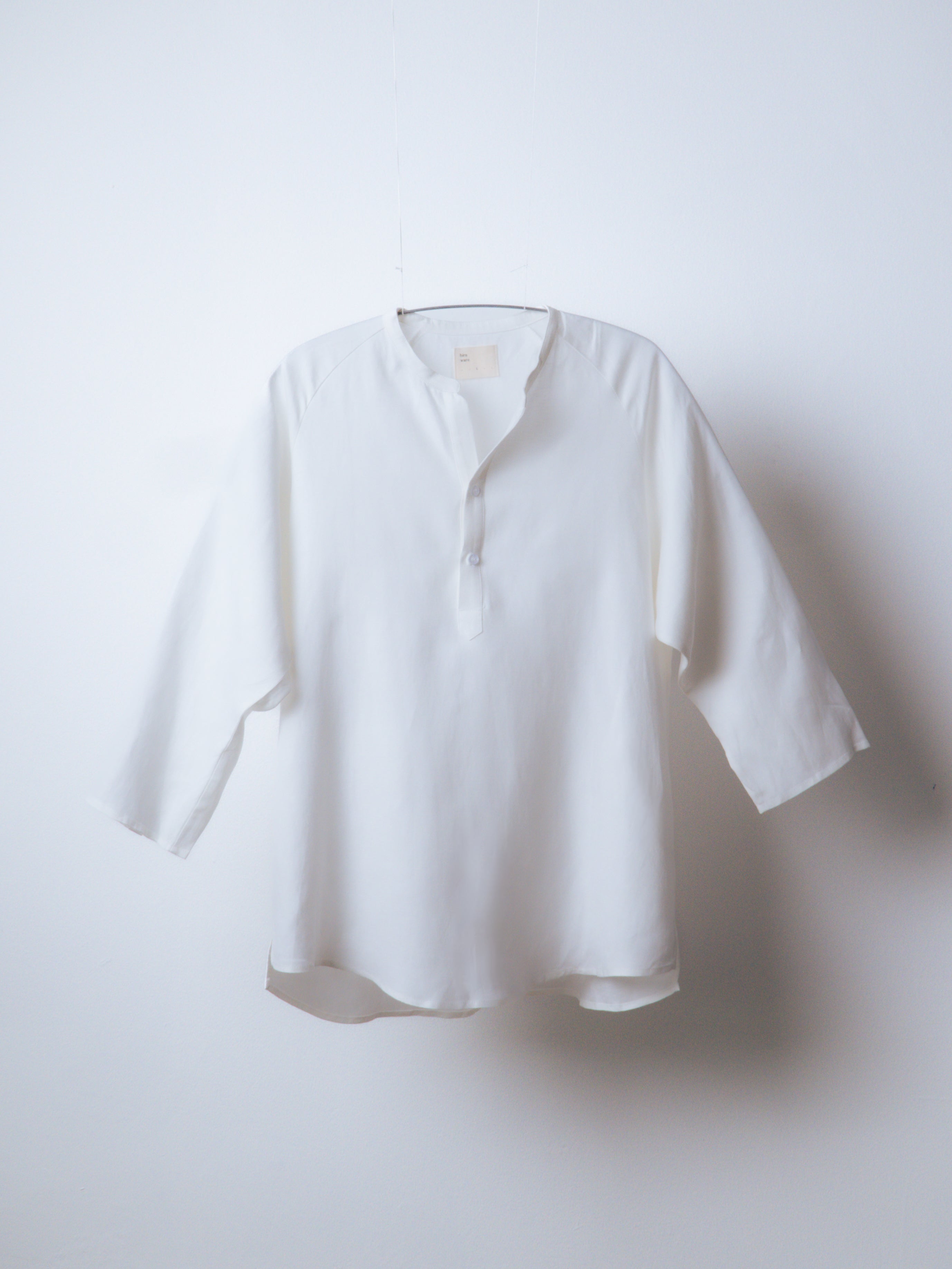 A Eckhaus Latta Shirt pictured on a model in front of a white background. The title of the product is Eckhaus Latta Eclipse Turtleneck - Stone and the image was taken by 199A®.
